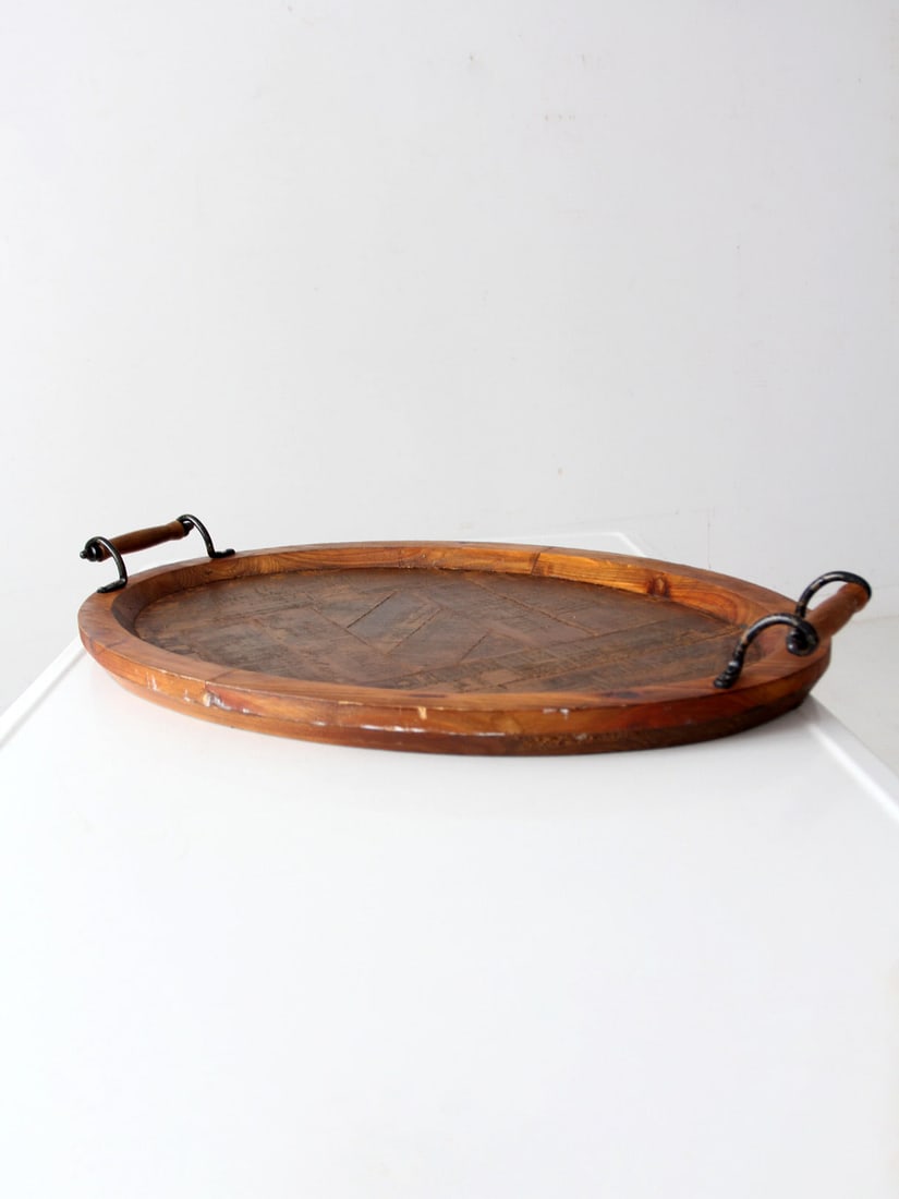 Vintage Oval Wood Tray with Metal Handles 30 x 19: Vintage Oval Wood Tray with Metal Handles 30 x 19 This vintage rustic wood tray showcases a gently oval shape complemented by dark metal handles and turned wood grips. The recessed surface features a 