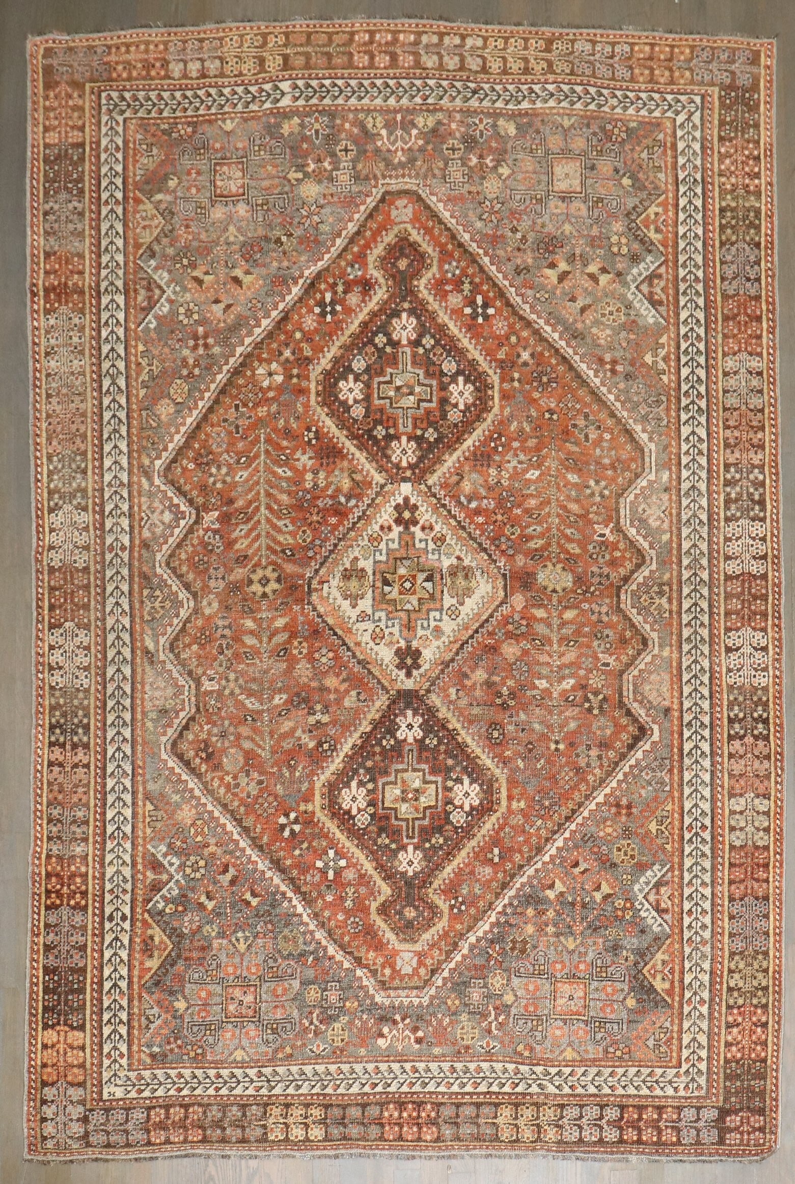 5' 4" x 7' 7" Antique Persian Shiraz Tribal Rug: 5' 4" x 7' 7" Antique Persian Shiraz Tribal Rug Early 20th century tribal Persian Shiraz rug in rustic tones. This pre-owned antique rug is identified as an intermediate category Shiraz piece. Specifi