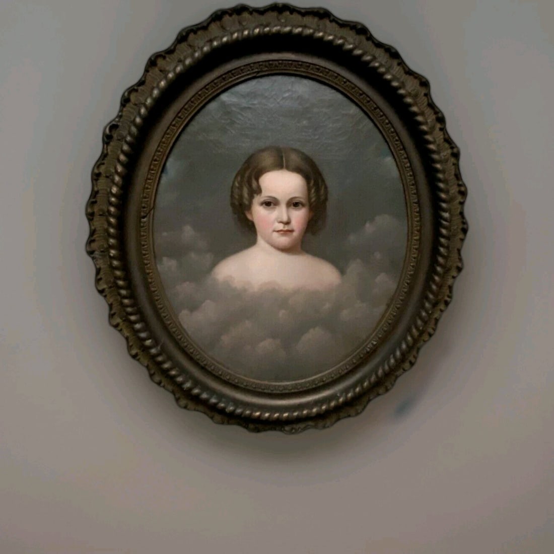 Framed 1847 Oil on Canvas Portrait of Young Girl with San Francisco Label: Framed 1847 Oil on Canvas Portrait of Young Girl with San Francisco Label Antique original oil on canvas portrait painting depicting a young girl in clouds, presented in an oval frame. The work is des