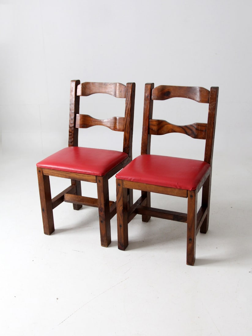 Rustic Vintage Wood Dining Chairs Pair with Red Faux Leather Seats: Rustic Vintage Wood Dining Chairs Pair with Red Faux Leather Seats This pair of vintage rustic wood dining chairs showcases a charming blend of style and comfort, featuring upholstered seats in vibran