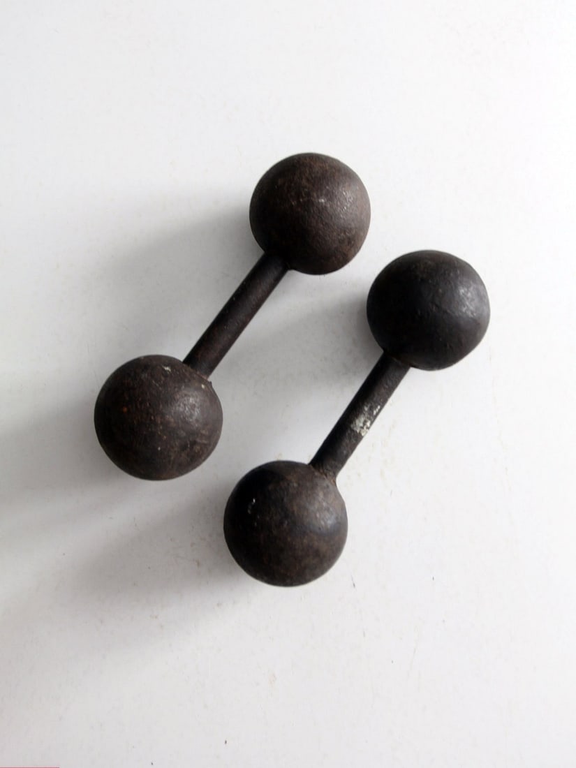 Antique Cast Iron Dumbbell Hand Weights Pair 9 inch: Antique Cast Iron Dumbbell Hand Weights Pair 9 inch This pair of antique cast iron dumbbell hand weights showcases a classic design that brings character to any space. The weights are in good conditio