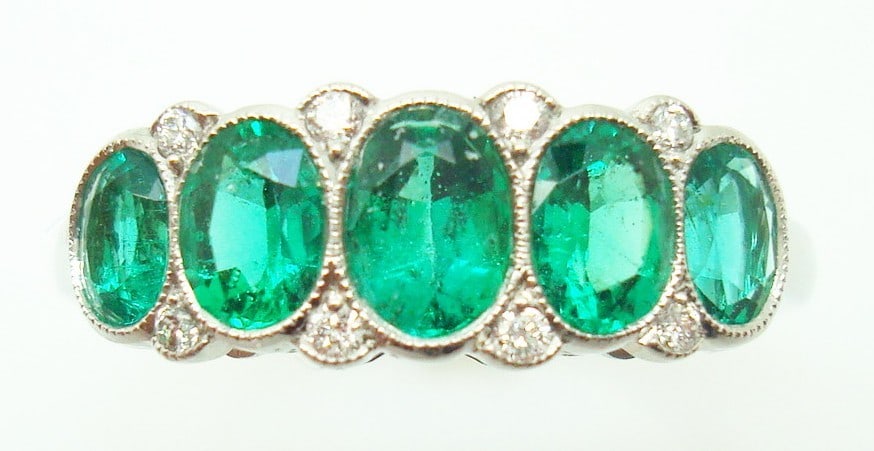 Platinum Ring with Five Oval Emeralds and Diamond Accents Size 6.25: Platinum Ring with Five Oval Emeralds and Diamond Accents Size 6.25 This very fine platinum ring features five genuine natural oval-cut emeralds with a vibrant grass green color, complemented by small