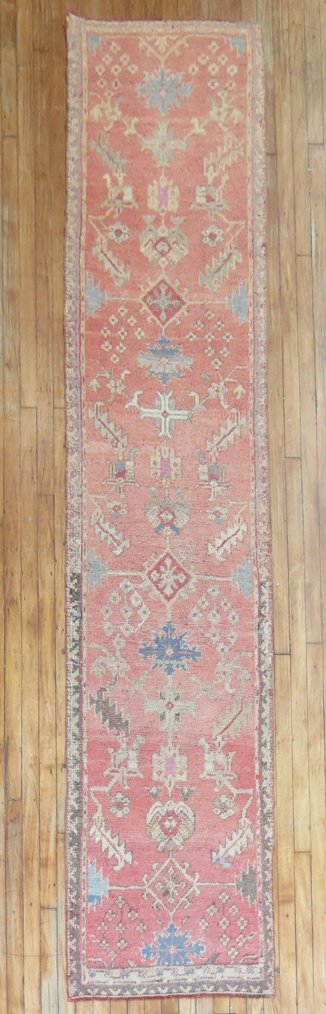 2' 5" x 11' 5" Antique Oushak Rug Runner in Soft Pink: 2' 5" x 11' 5" Antique Oushak Rug Runner in Soft Pink Early 20th century antique Oushak runner in a soft pink color. This pre-owned rug features the classic Oushak runner form and retains its antique 