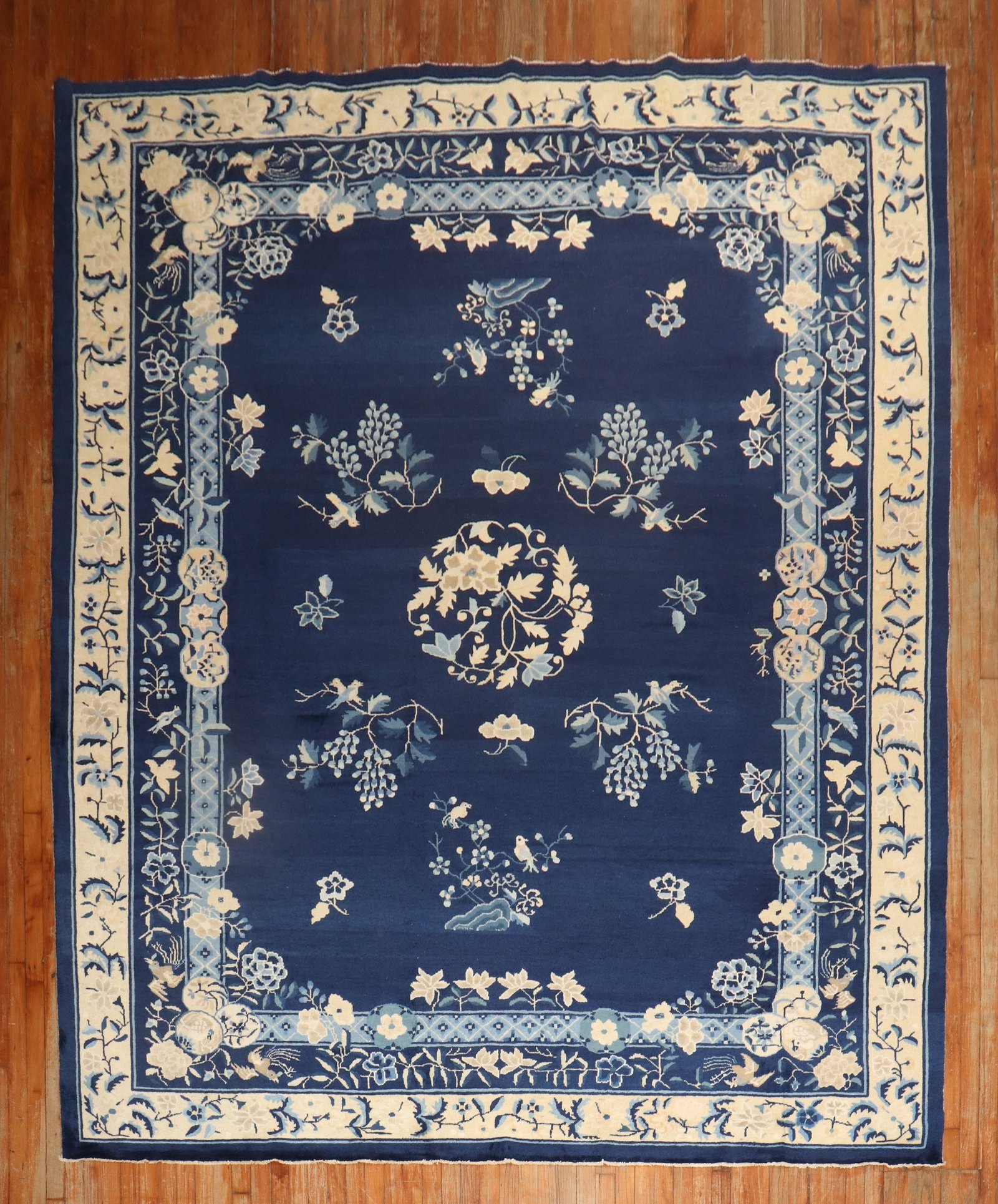 8' 11" x 11' 6" Peking Chinese floral room rug navy field: 8' 11" x 11' 6" Peking Chinese floral room rug navy field Early 20th century Chinese Peking room-size floral rug with a navy field and beige and light blue accents. The design features floral and vine