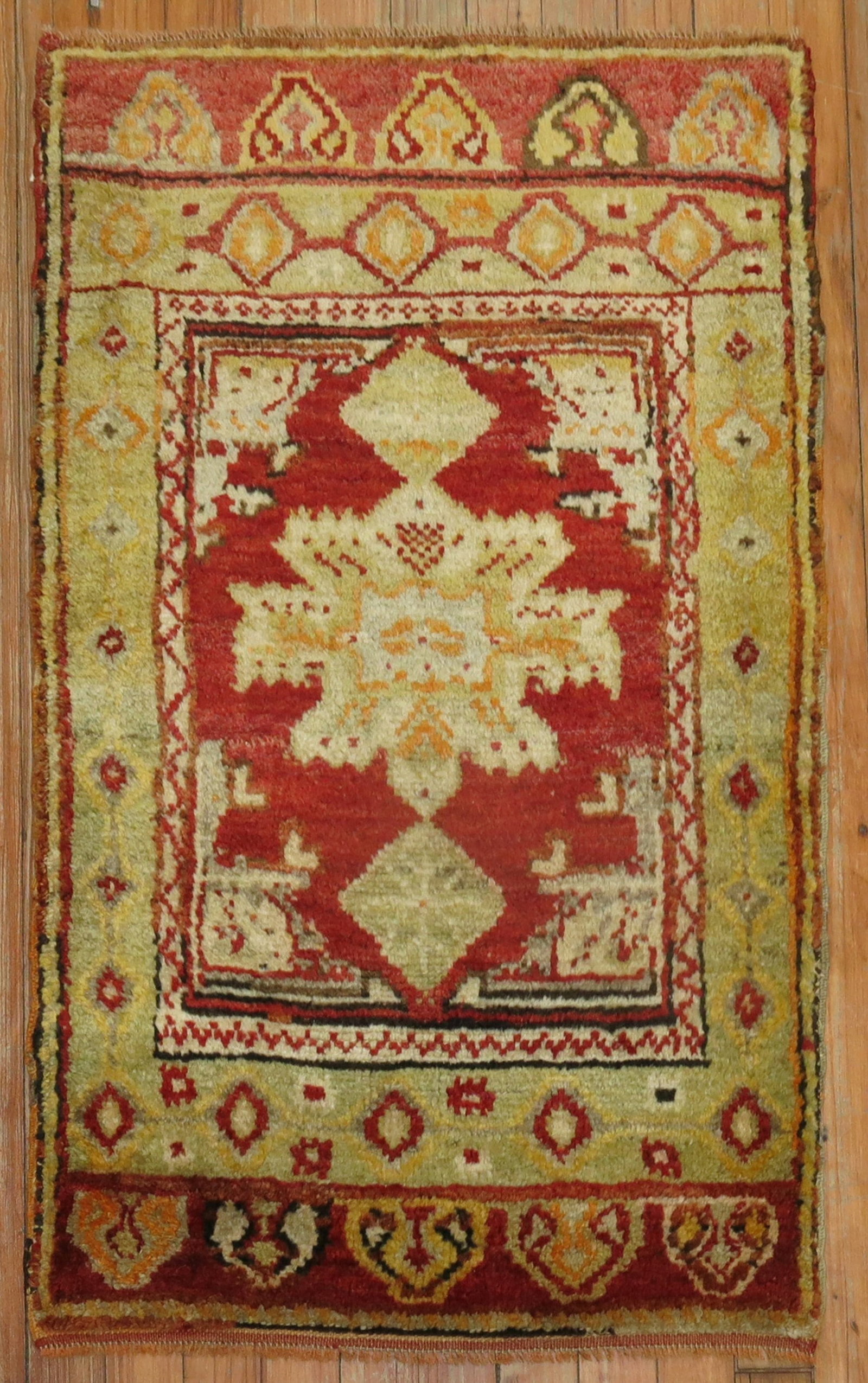 Early 20th Century Turkish Yastik Rug 1' 11" x 3' Cherry Red: Early 20th Century Turkish Yastik Rug 1' 11" x 3' Cherry Red An early 20th century Turkish Yastik rug in cherry red with a full, even pile. This pre-owned piece features a geometric pattern and is pre