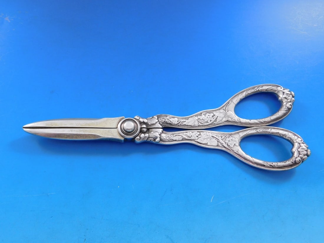 Tiffany & Co Sterling Silver Lap Over Edge Grape Shears 7 3/4 inches: Tiffany & Co Sterling Silver Lap Over Edge Grape Shears 7 3/4 inches This stunning pair of grape shears from Tiffany & Co. showcases the exquisite Lap Over Edge pattern, featuring intricate acid etchi