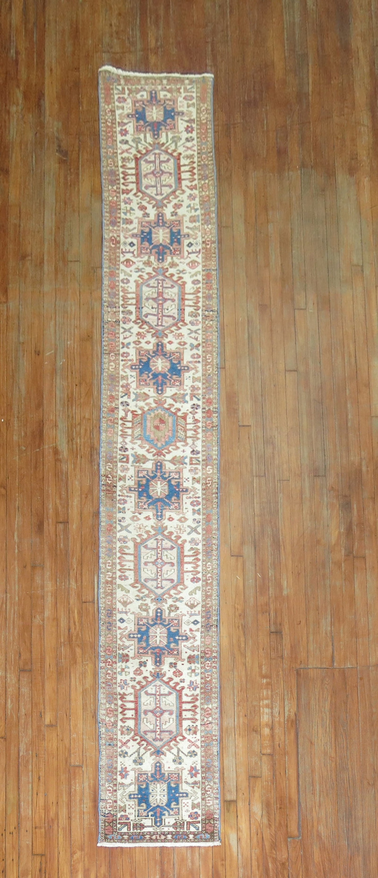 1' 10" x 12' 4" Persian Serapi Heriz Rug Runner Ivory: 1' 10" x 12' 4" Persian Serapi Heriz Rug Runner Ivory A skinny mid-20th century Persian Heriz runner with an ivory field. This pre-owned runner is identified as a Serapi/Heriz type. Specifications Typ