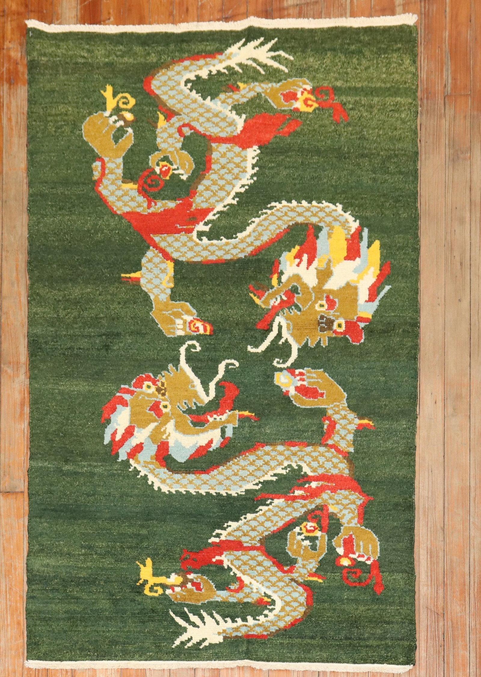 3' x 5' Tibetan Pictorial Wool Rug with Dragon Motif: 3' x 5' Tibetan Pictorial Wool Rug with Dragon Motif Tibetan pictorial rug featuring a dragon motif on a green field. This pre-owned small rug dates to the 3rd quarter of the 20th century. Specificati