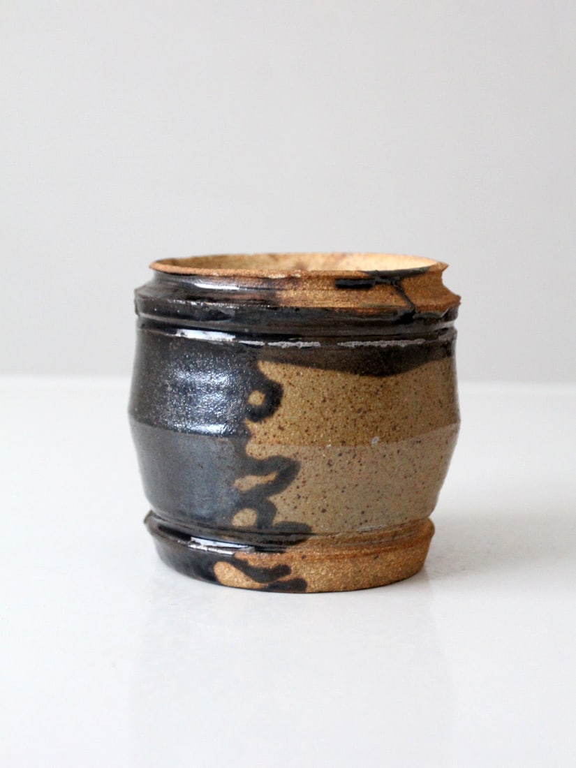 Rounded Studio Pottery Vase with Tan Brown and Black Glaze: Rounded Studio Pottery Vase with Tan Brown and Black Glaze This vintage studio pottery vase features a rounded form with a layered glaze showcasing warm tan, deep brown, and flowing black accents. The