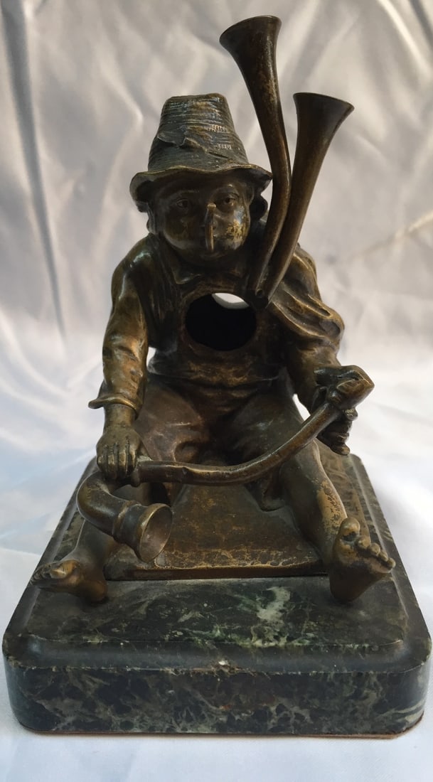 19th Century Austrian Bronze Watch Holder by Korff on Marble Base: 19th Century Austrian Bronze Watch Holder by Korff on Marble Base This exquisite 19th-century Austrian bronze watch holder showcases a captivating design featuring a boy blowing into a pipe, which cle