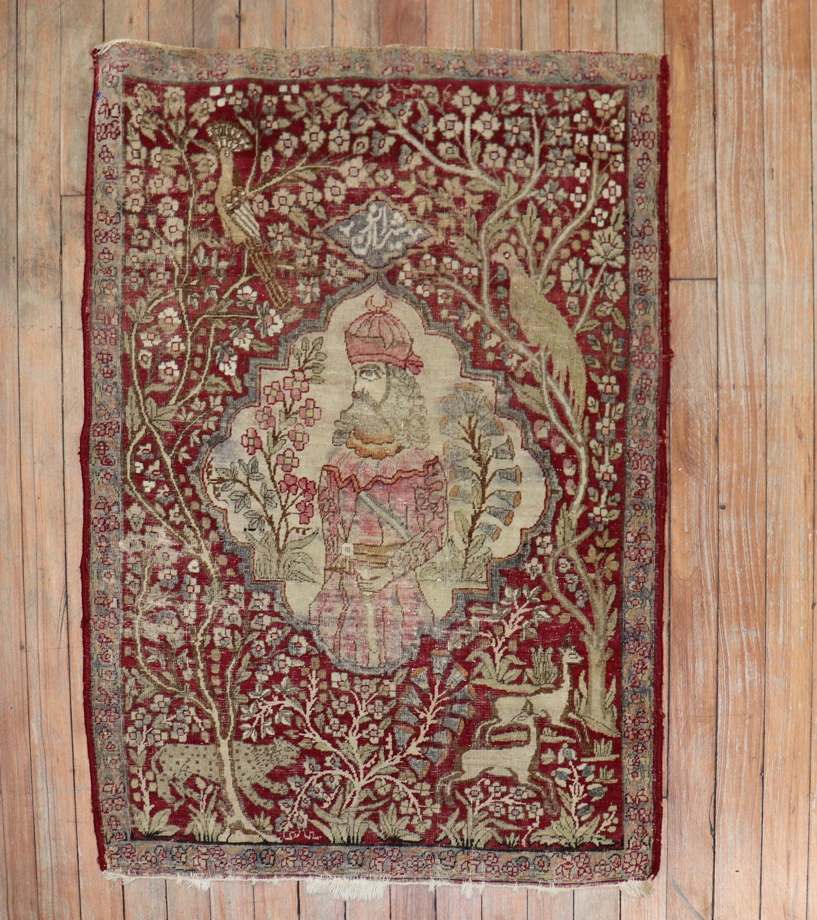 2' 4" x 3' 3" Persian Kerman pictorial rug: 2' 4" x 3' 3" Persian Kerman pictorial rug Early 20th century Persian Kerman pictorial rug with an animal-themed design. This pre-owned small rug features the distinctive pictorial style noted in the 