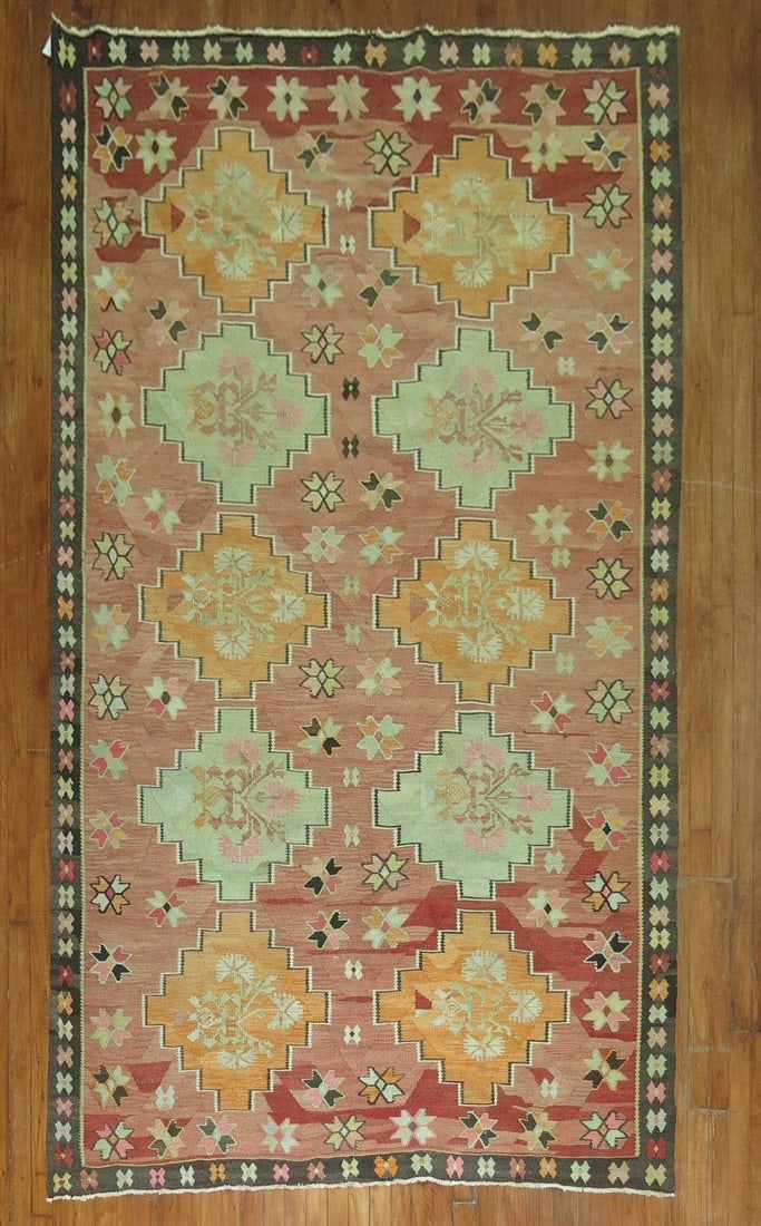 5' 7" x 10' 7" Mid 20th Century Turkish Kilim Rug: 5' 7" x 10' 7" Mid 20th Century Turkish Kilim Rug Vintage Turkish kilim with a rustic color palette and traditional geometric design. This mid-20th century gallery-size rug is a pre-owned piece. Speci