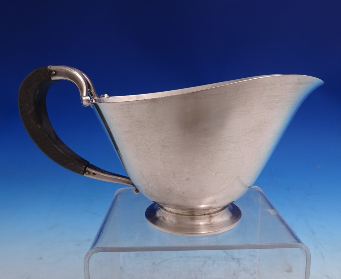 Sterling Silver Sauce Boat With Wood Handle Pattern 896 By Georg Jensen: Sterling Silver Sauce Boat With Wood Handle Pattern 896 By Georg Jensen This Georg Jensen gravy boat is crafted from sterling silver and features a wood handle. Designed in pattern number 896, the pie