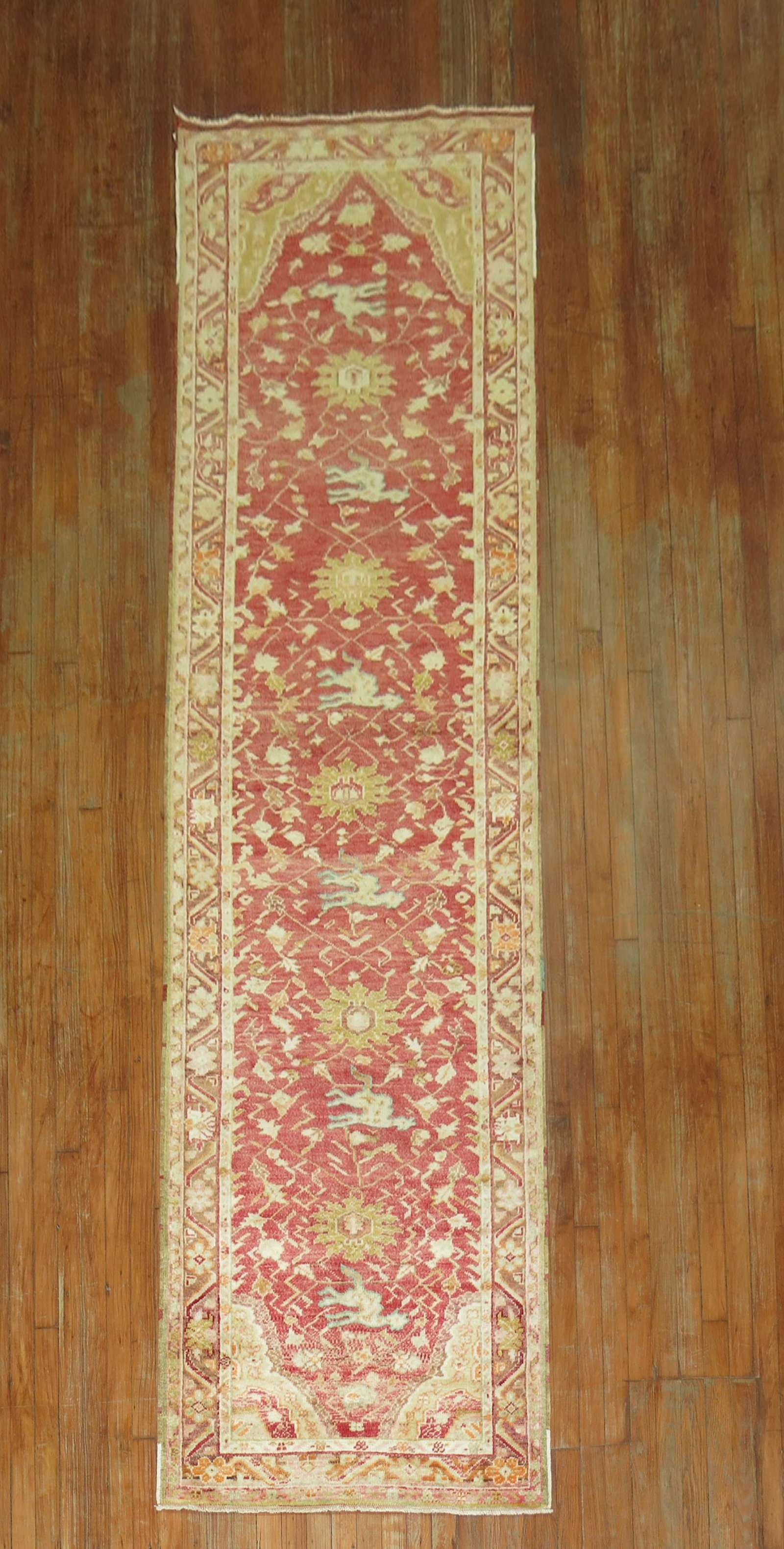 3' x 11' 5" Turkish Oushak pictorial rug runner: 3' x 11' 5" Turkish Oushak pictorial rug runner Antique Turkish Oushak pictorial runner with light blue highlighted animal motifs on a red ground. This pre-owned rug presents a distinctive decorative 