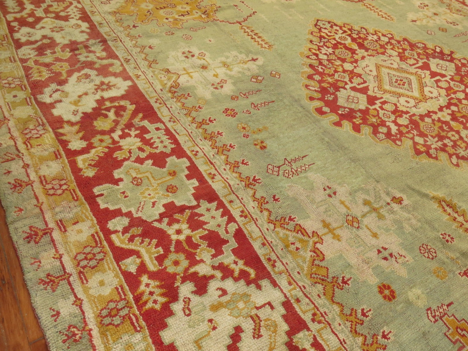 13' 8" x 15' 3" Square Turkish Oushak Rug Light Green Red Medallion: 13' 8" x 15' 3" Square Turkish Oushak Rug Light Green Red Medallion Early 20th century antique Turkish Oushak square rug with a red medallion and border on a light green field. Presented in full pile 
