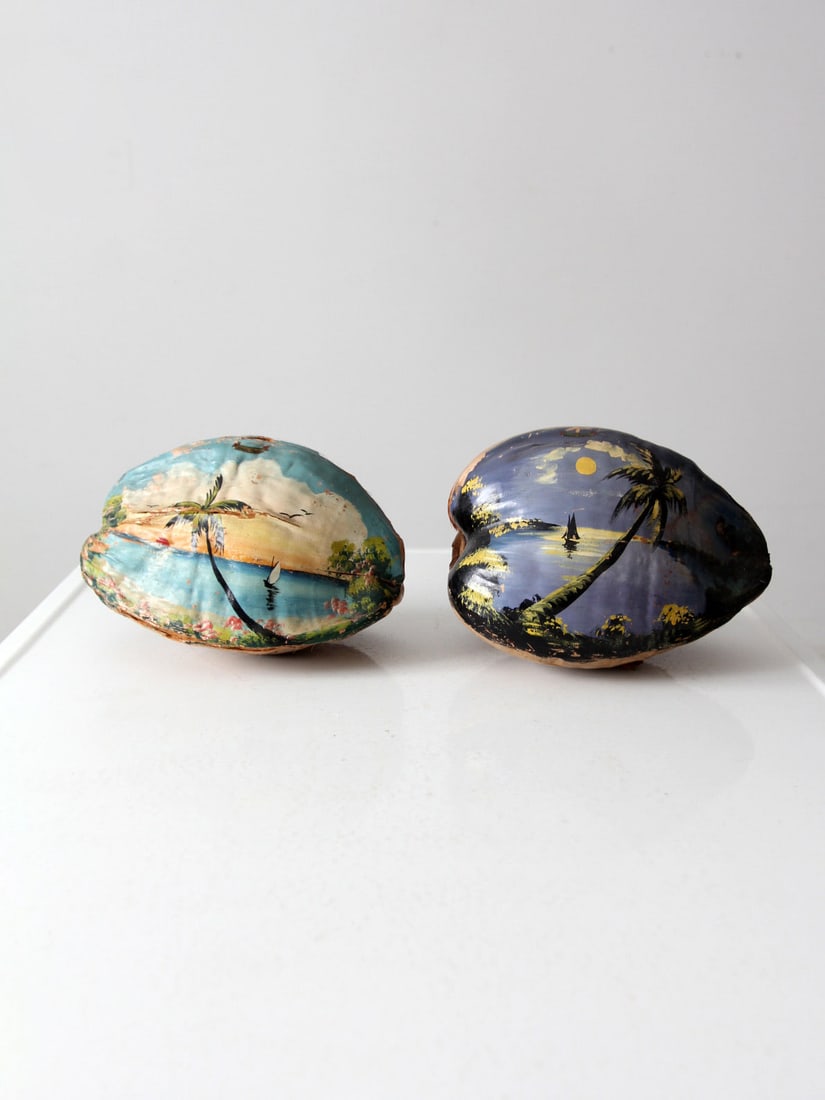 Vintage Hand Painted Coconut Souvenir Set from Miami: Vintage Hand Painted Coconut Souvenir Set from Miami This exquisite pair of vintage hand-painted coconuts serves as charming souvenirs from Miami, Florida. Each coconut is uniquely adorned with vibran