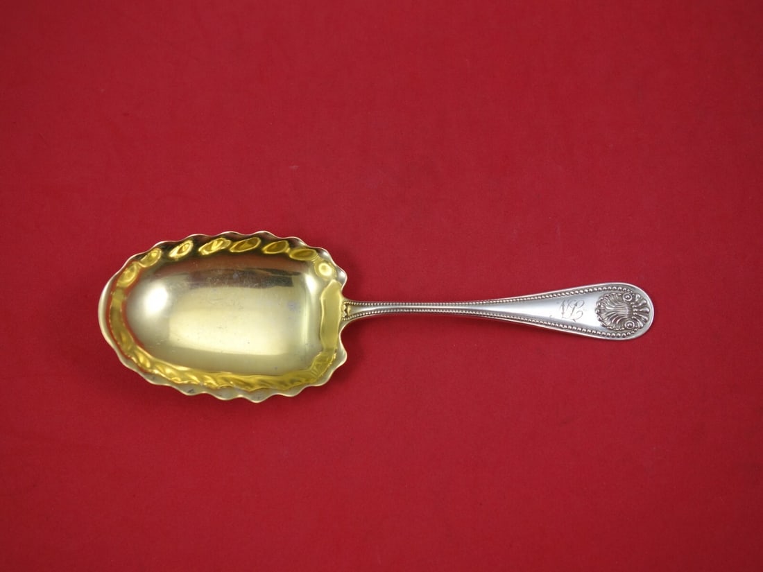 Whiting Bead Sterling Silver Preserve Spoon Gold Washed 6 5/8": Whiting Bead Sterling Silver Preserve Spoon Gold Washed 6 5/8" Sterling silver preserve spoon in the Bead pattern by Whiting, featuring a gold washed finish. This pre-owned serving spoon is monogramme