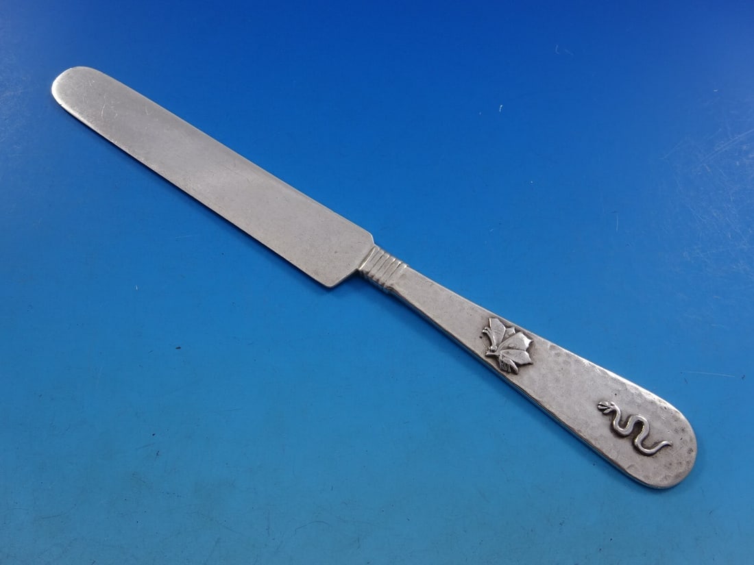 Shiebler Sterling Silver Tea Knife Aesthetic Snake Butterfly 8": Shiebler Sterling Silver Tea Knife Aesthetic Snake Butterfly 8" This exquisite tea knife, crafted by Shiebler, showcases a stunning hammered and applied design characteristic of the Aesthetic movement