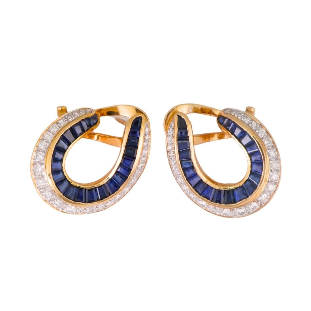 Baguette Sapphire and Diamond Stud Earrings in 18K Yellow Gold: Baguette Sapphire and Diamond Stud Earrings in 18K Yellow Gold Well-crafted 18K yellow gold stud earrings featuring natural dark blue baguette-cut sapphires accented by round brilliant-cut diamonds. D