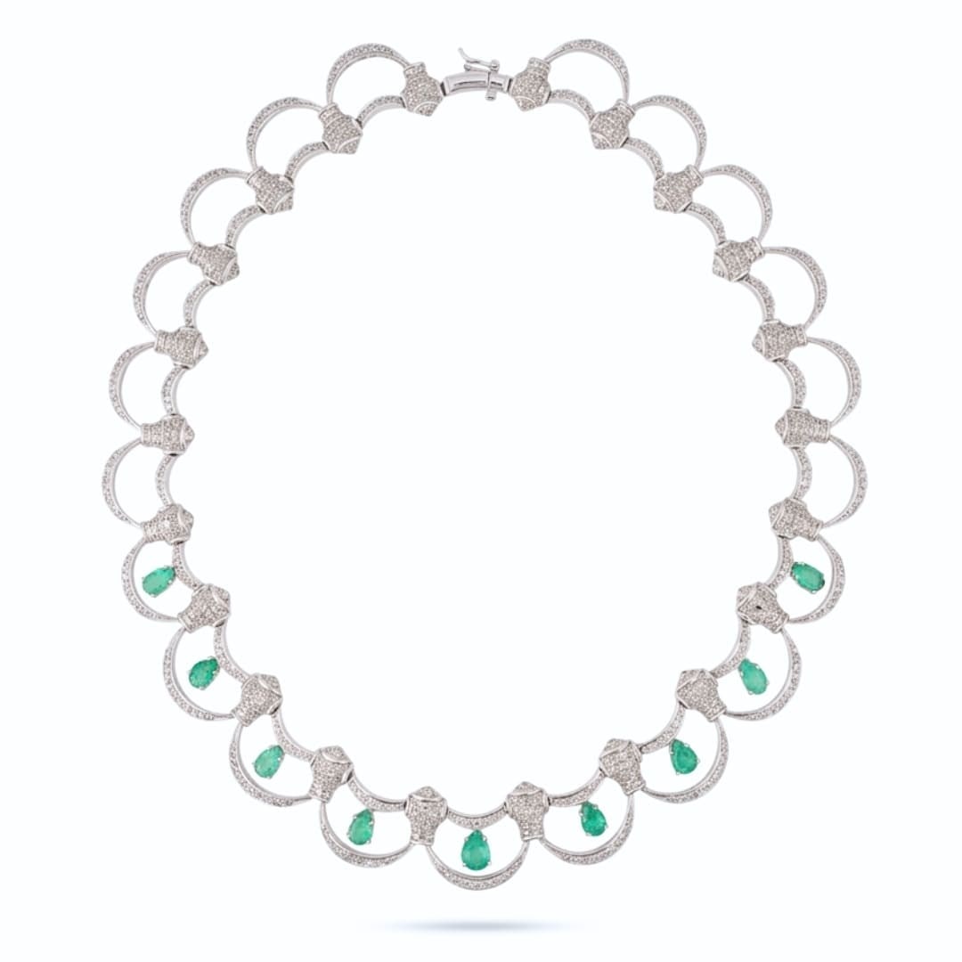 Statement Necklace in 18K White Gold with Colombian Emeralds and Diamonds: Statement Necklace in 18K White Gold with Colombian Emeralds and Diamonds Statement necklace crafted in 18K white gold and set with natural Colombian emeralds and round brilliant cut diamonds. The nec