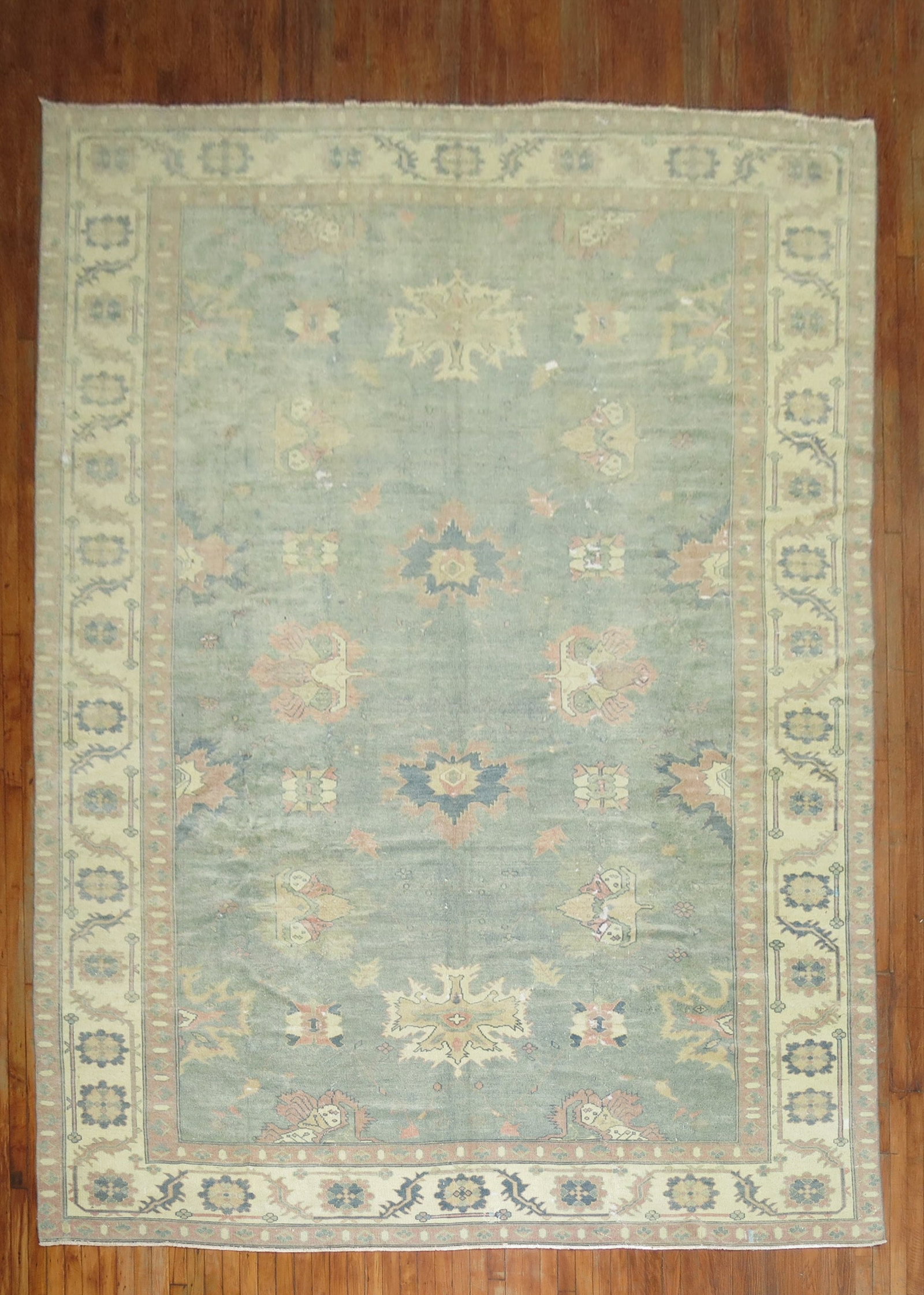 9' x 13' 6" Oushak Room Rug in Feminine Colors: 9' x 13' 6" Oushak Room Rug in Feminine Colors A worn Oushak room rug from the 3rd quarter of the 20th century, presented in feminine colors. The design features a classic patterned field consistent w