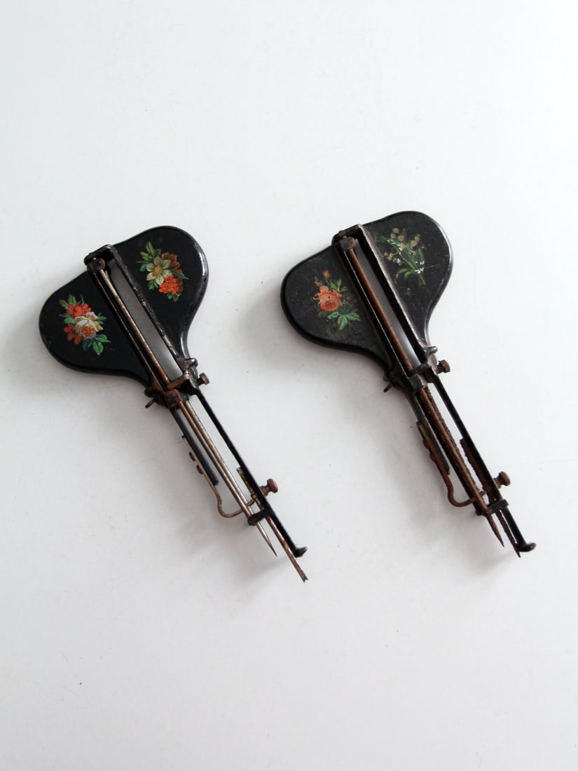 Set of Two Late 19th Century Jewel Hand Stitch Tools with Floral Detailing: Set of Two Late 19th Century Jewel Hand Stitch Tools with Floral Detailing This pair of antique Jewel hand stitchers dates to the late 19th century. Each tool features a japanned black body adorned wi
