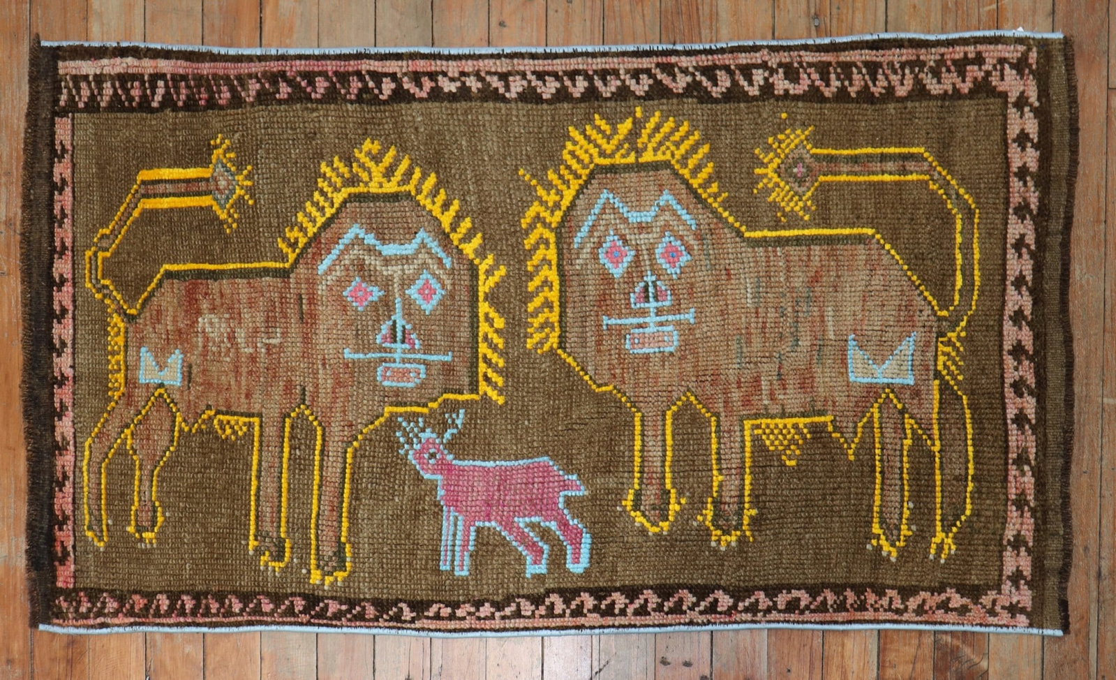 1' 10" x 3' 6" Turkish pictorial rug with lions and sheep: 1' 10" x 3' 6" Turkish pictorial rug with lions and sheep Late 20th-century Turkish pictorial rug dated 1980, featuring two lions outlined in yellow and a pink sheep outlined in light blue on a brown 
