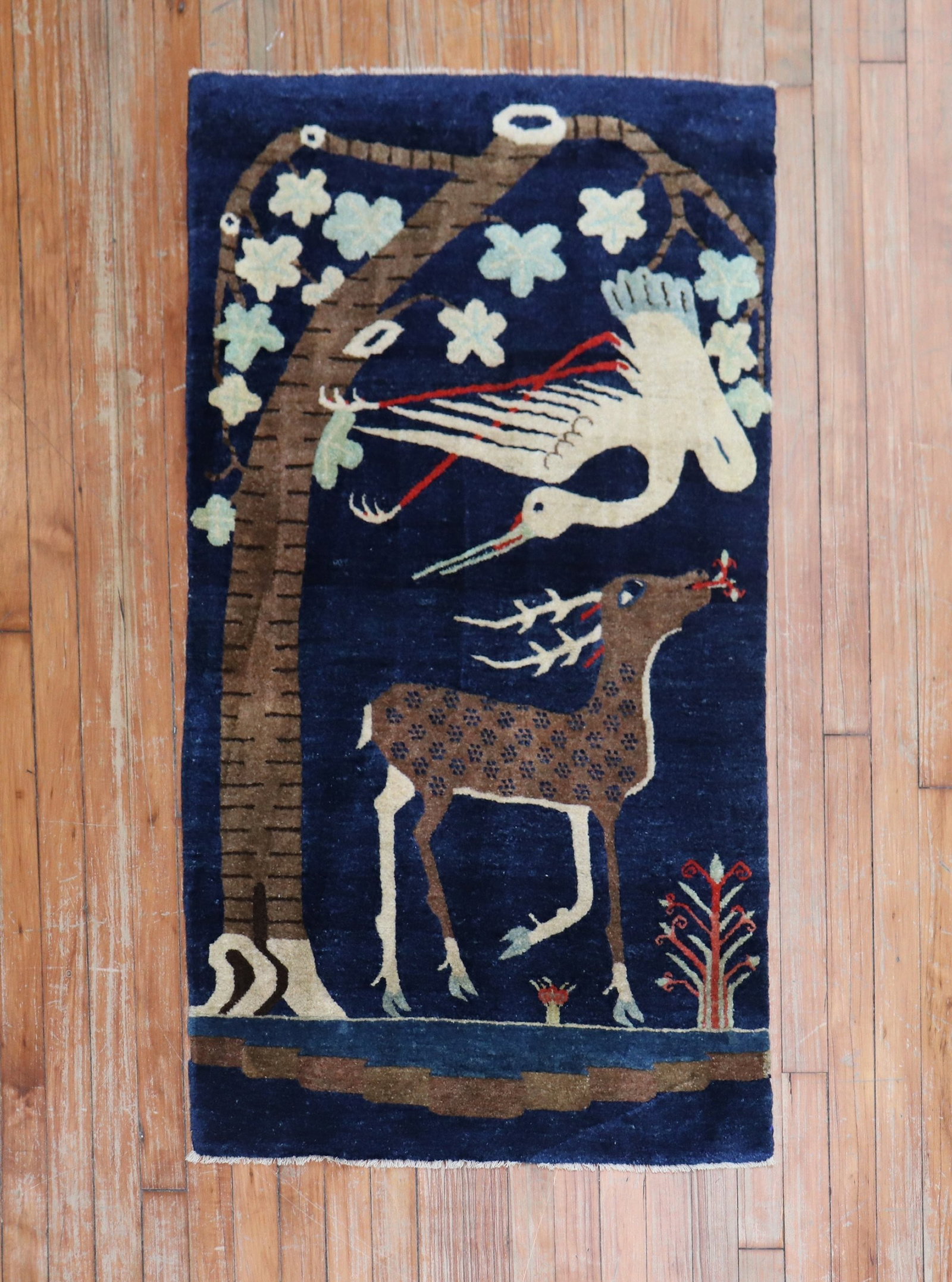 2' 5" x 4' 6" Tibetan Pictorial Rug with Deer and Bird: 2' 5" x 4' 6" Tibetan Pictorial Rug with Deer and Bird A circa 1930s Tibetan pictorial rug featuring a large deer and bird set against a deep blue ground. This pre-owned small rug offers a distinctive