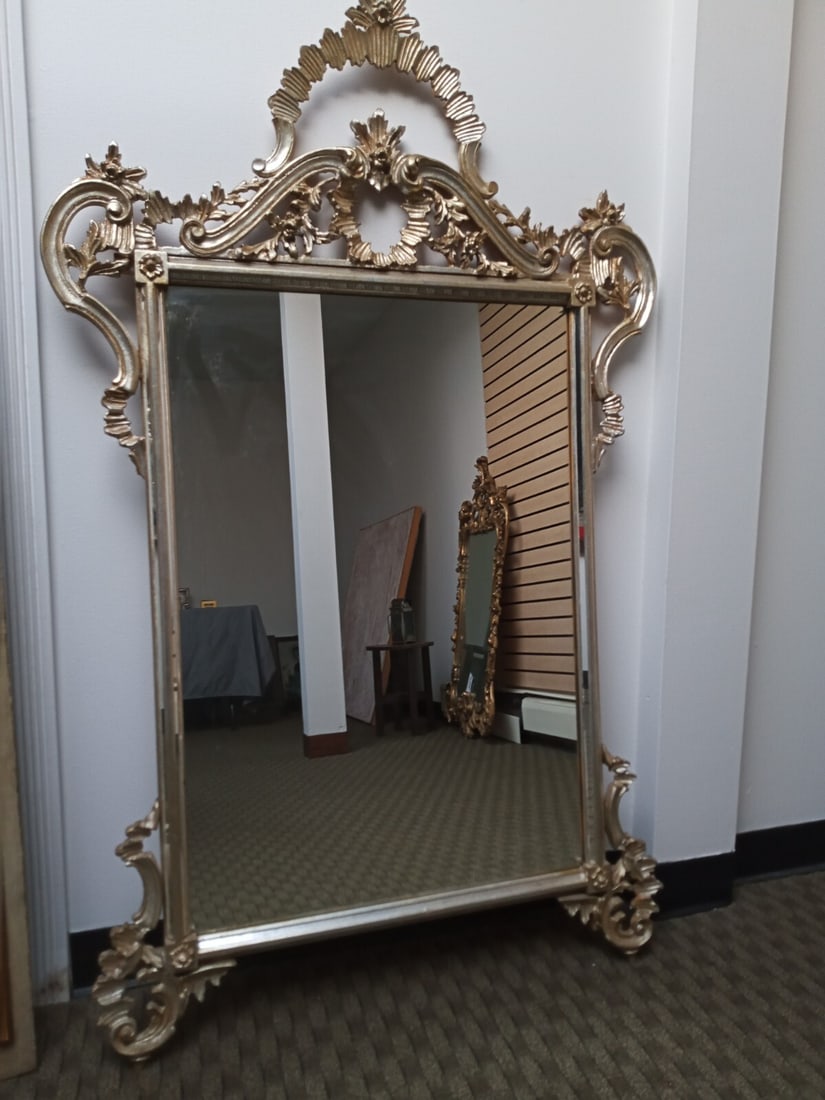 35 by 57.5 Italian Florentine carved giltwood wall mirror: 35 by 57.5 Italian Florentine carved giltwood wall mirror Large Italian or Florentine wall mirror with a hand-carved wood frame in a silver giltwood finish with faint gold highlights. This rectangular