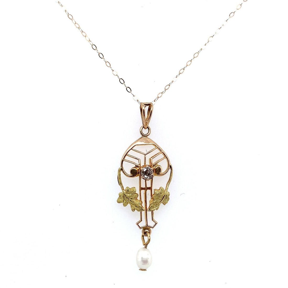 Victorian Era 10k Yellow Gold Diamond Lavaliere Pendant with Leaf Motif and Pearl Drop: Victorian Era 10k Yellow Gold Diamond Lavaliere Pendant with Leaf Motif and Pearl Drop This Victorian-era lavaliere pendant is crafted from 10k yellow gold and features delicate green gold leaves. The