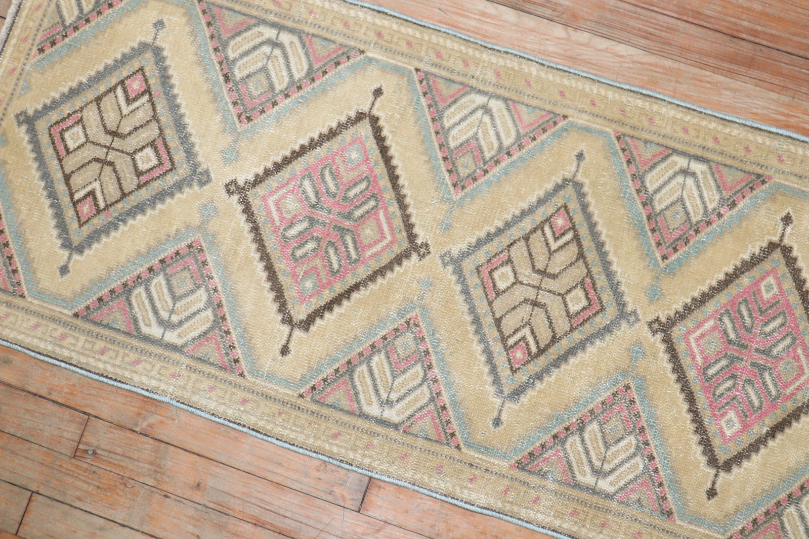2' x 4' 2" Small Persian Rug with Geometric Design: 2' x 4' 2" Small Persian Rug with Geometric Design Vintage Persian rug featuring a geometric design with brown, pink, and gray accents on a camel ground. This pre-owned small rug offers a classic deco