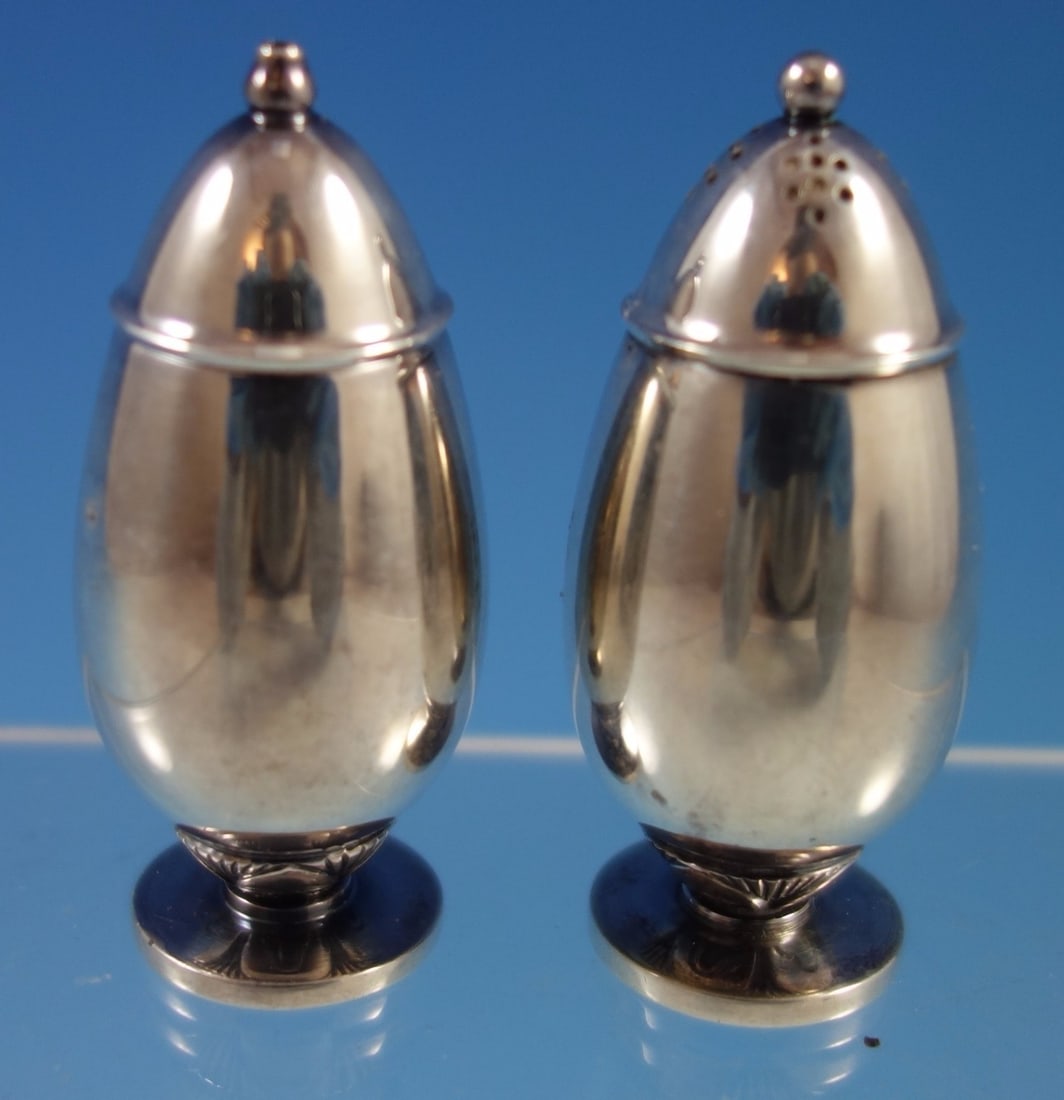 Georg Jensen Cactus Sterling Silver Salt Pepper Shakers 2pc Set: Georg Jensen Cactus Sterling Silver Salt Pepper Shakers 2pc Set Enhance your dining experience with this exquisite 2-piece set of Cactus pattern salt and pepper shakers by Georg Jensen. Crafted from h