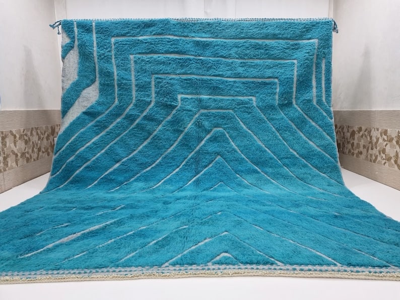 Handwoven Luxury Blue Engraved Rug 100% Sheep Wool Morocco 10 x 8 Feet: Handwoven Luxury Blue Engraved Rug 100% Sheep Wool Morocco 10 x 8 Feet Discover the exquisite Luxury Blue Engraved Rug, a stunning piece handwoven in the Atlas Mountains by skilled local Berber women.