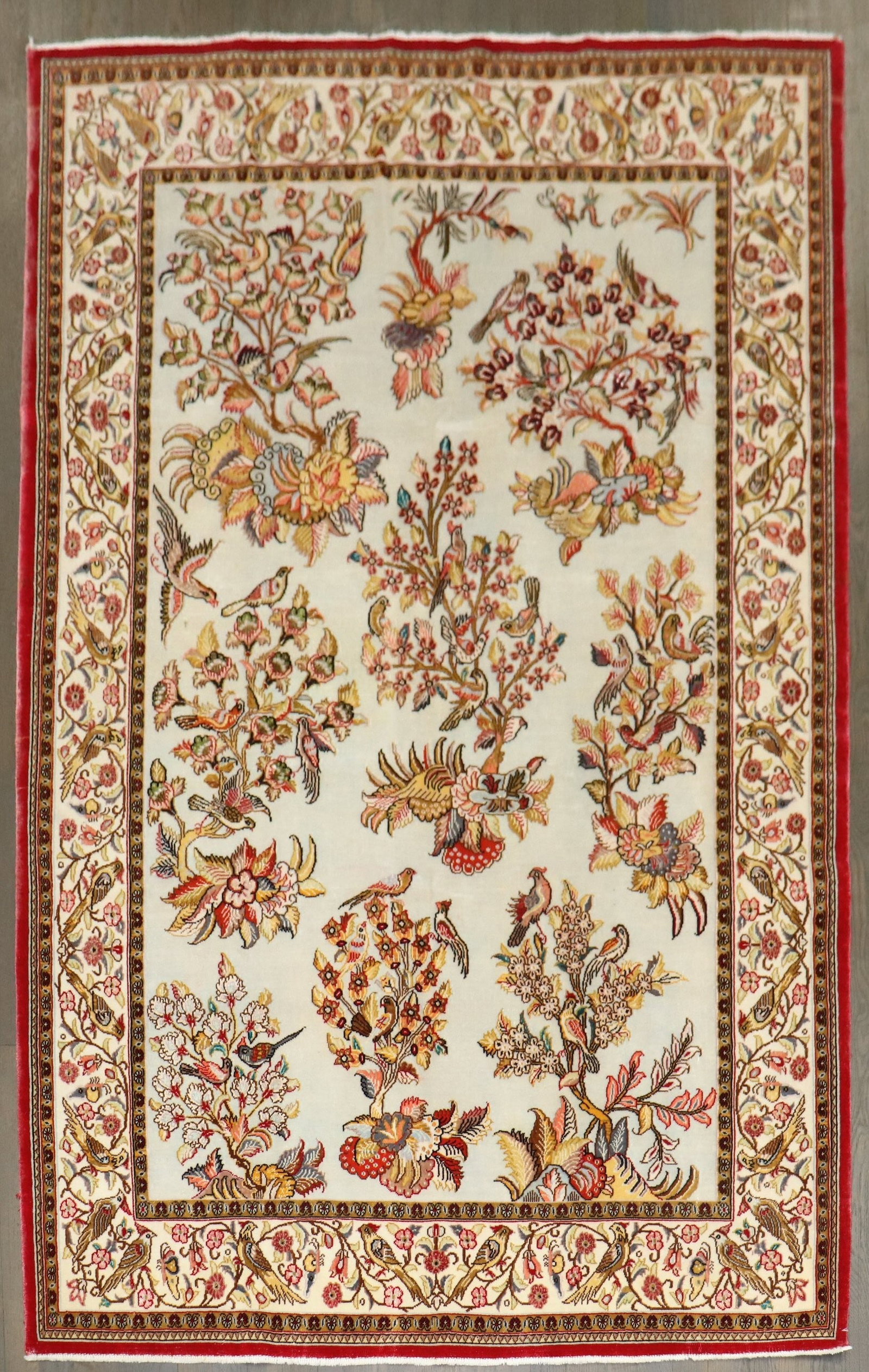 4' 5" x 6' 9" Persian Qum part silk accent rug: 4' 5" x 6' 9" Persian Qum part silk accent rug Persian Qum accent rug featuring a floral bird pictorial design. This pre-owned piece is described as a cotton part silk rug from the 3rd quarter of the 