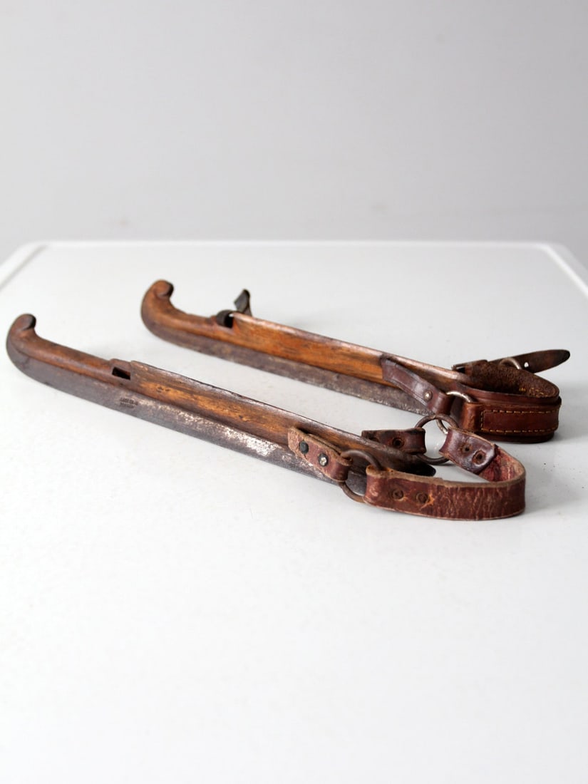 Antique J Noorman Denham Mismatched Ice Skates Pair: Antique J Noorman Denham Mismatched Ice Skates Pair This unique pair of antique J Noorman Denham ice skates dates back to the late 19th to early 20th century. Crafted in the Netherlands, these wooden 