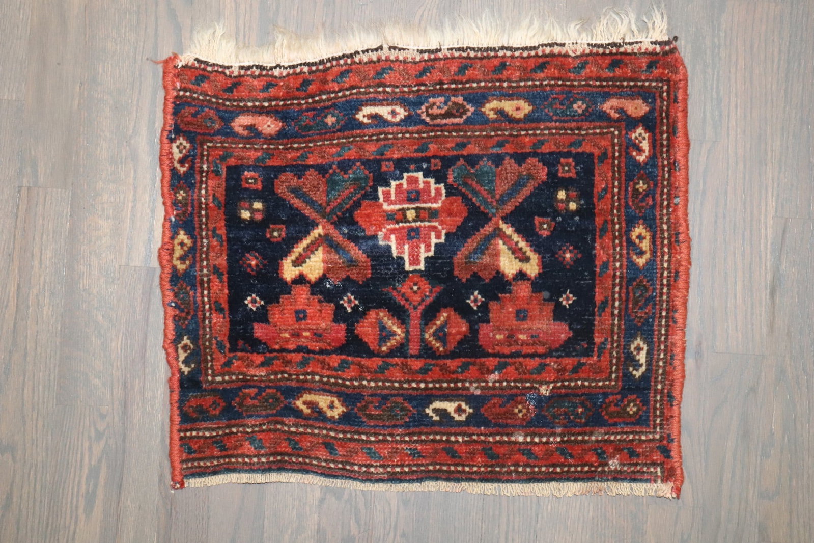 1' 6" x 1' 10" Persian Kurd Yastik Rug: 1' 6" x 1' 10" Persian Kurd Yastik Rug Early 20th century Persian Kurd rug with a geometric design and floral motifs. This pre-owned mini rug is categorized as a square yastik. Specifications Origin: 