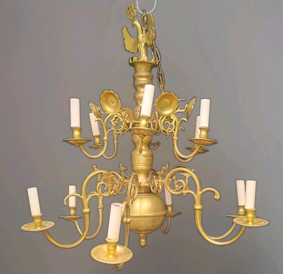 Antique Dutch Baroque brass 12 arm chandelier with eagle finial: Antique Dutch Baroque brass 12 arm chandelier with eagle finial Antique Dutch Baroque Revival chandelier with a 2-tier, 12-arm design in spun brass. This pre-1890 fixture has been electrified and func