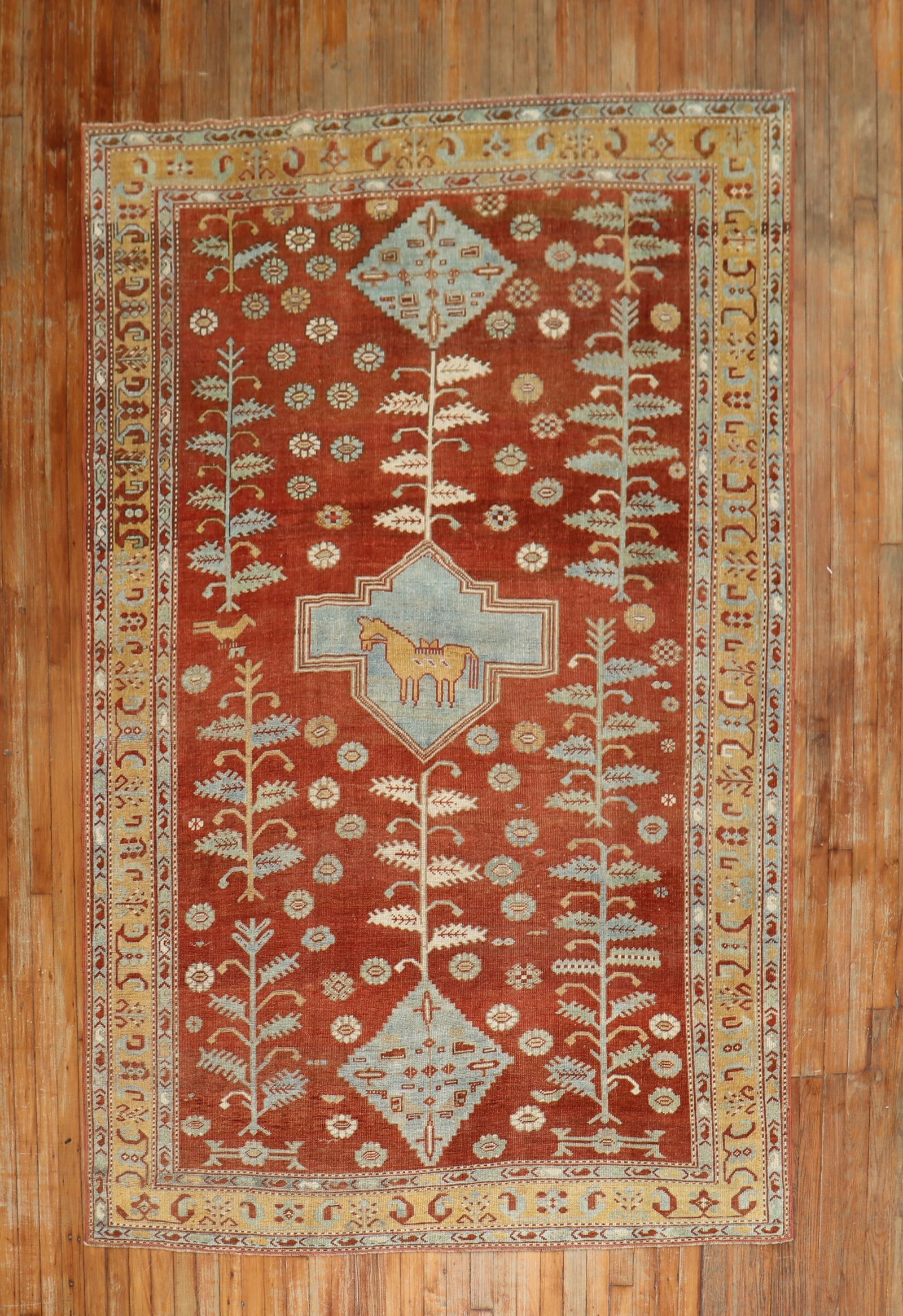 5' 9" x 8' 6" Pictorial Caucasian Rug with Camel Medallion: 5' 9" x 8' 6" Pictorial Caucasian Rug with Camel Medallion Geometric pictorial Caucasian rug from the second quarter of the 20th century, featuring a saffron ground, light blue accents, a goldenrod