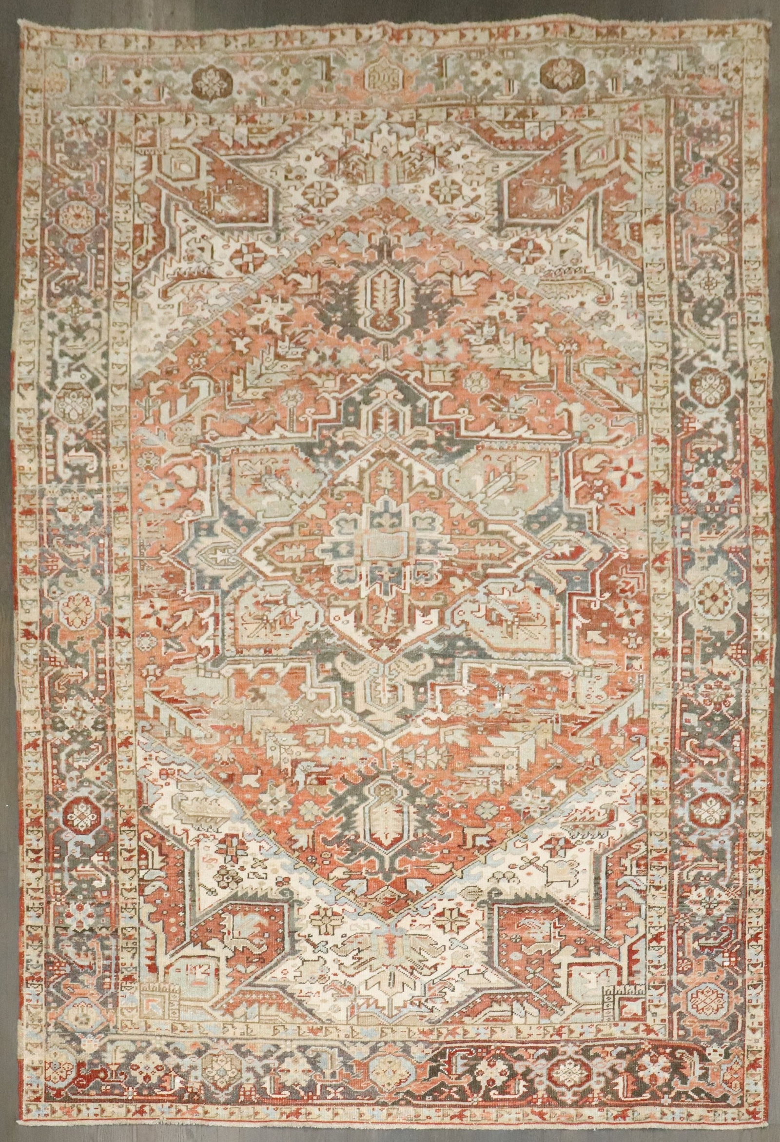 6' 8" x 9' 5" Persian Serapi Heriz Intermediate Rug: 6' 8" x 9' 5" Persian Serapi Heriz Intermediate Rug Early 20th century Persian Heriz rug in rustic earth-tone colors. This pre-owned intermediate-size rug is identified as a Serapi/Heriz type. Specifi