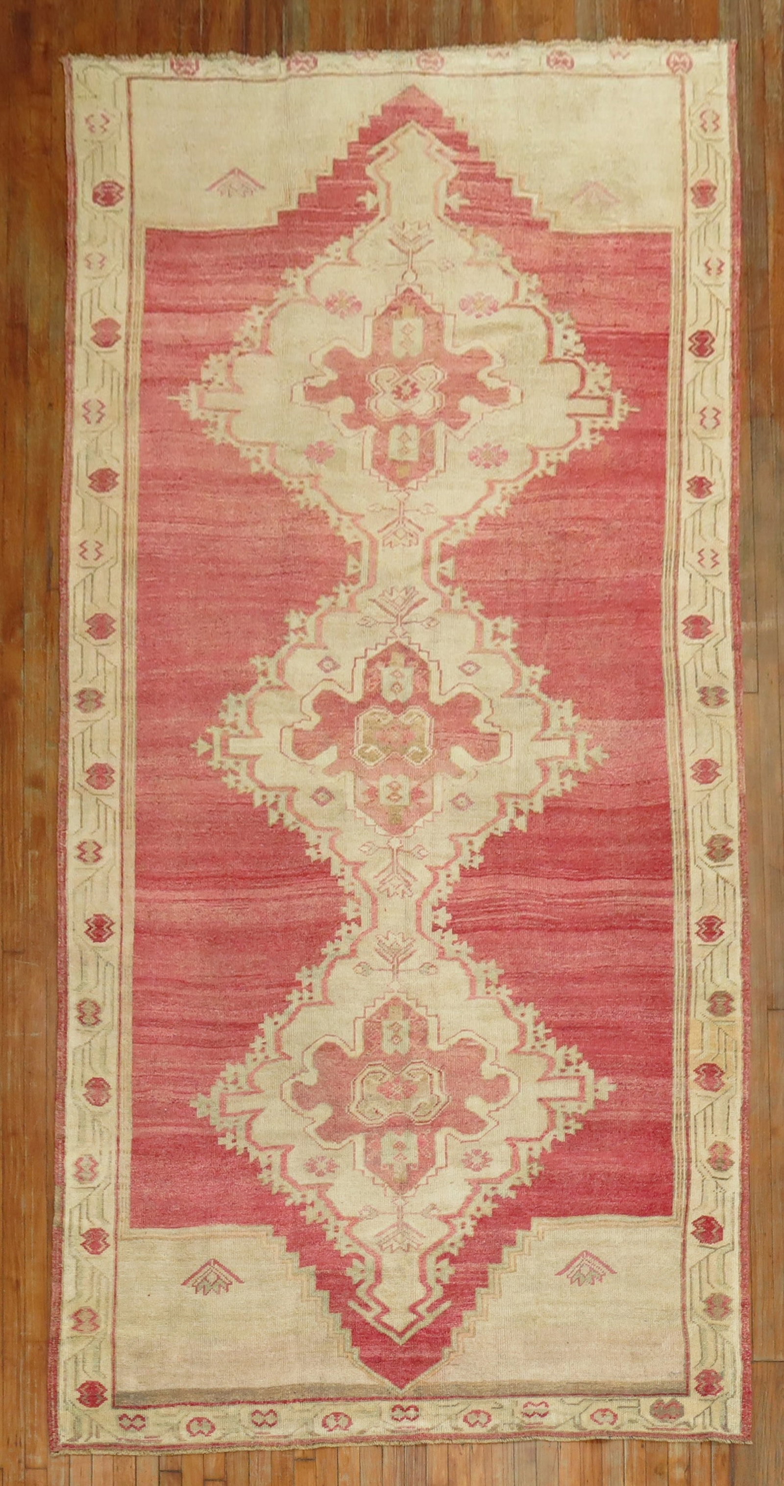 6' 1" x 12' 3" Kars Turkish Gallery Rug Pink Red Field: 6' 1" x 12' 3" Kars Turkish Gallery Rug Pink Red Field Mid 20th century Turkish gallery rug featuring three large medallions on a bright pink-red field. This pre-owned Kars rug presents a classic gall