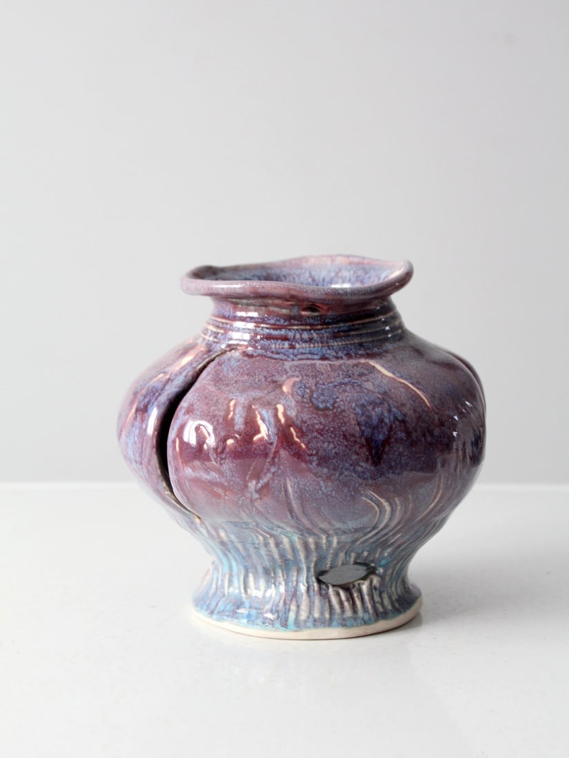 Vintage Abstract Studio Pottery Vase with Wabi-Sabi Design: Vintage Abstract Studio Pottery Vase with Wabi-Sabi Design This vintage studio pottery vase showcases an abstract design with a unique tilted 'crushed' form. It features intricate cut-out patterns and