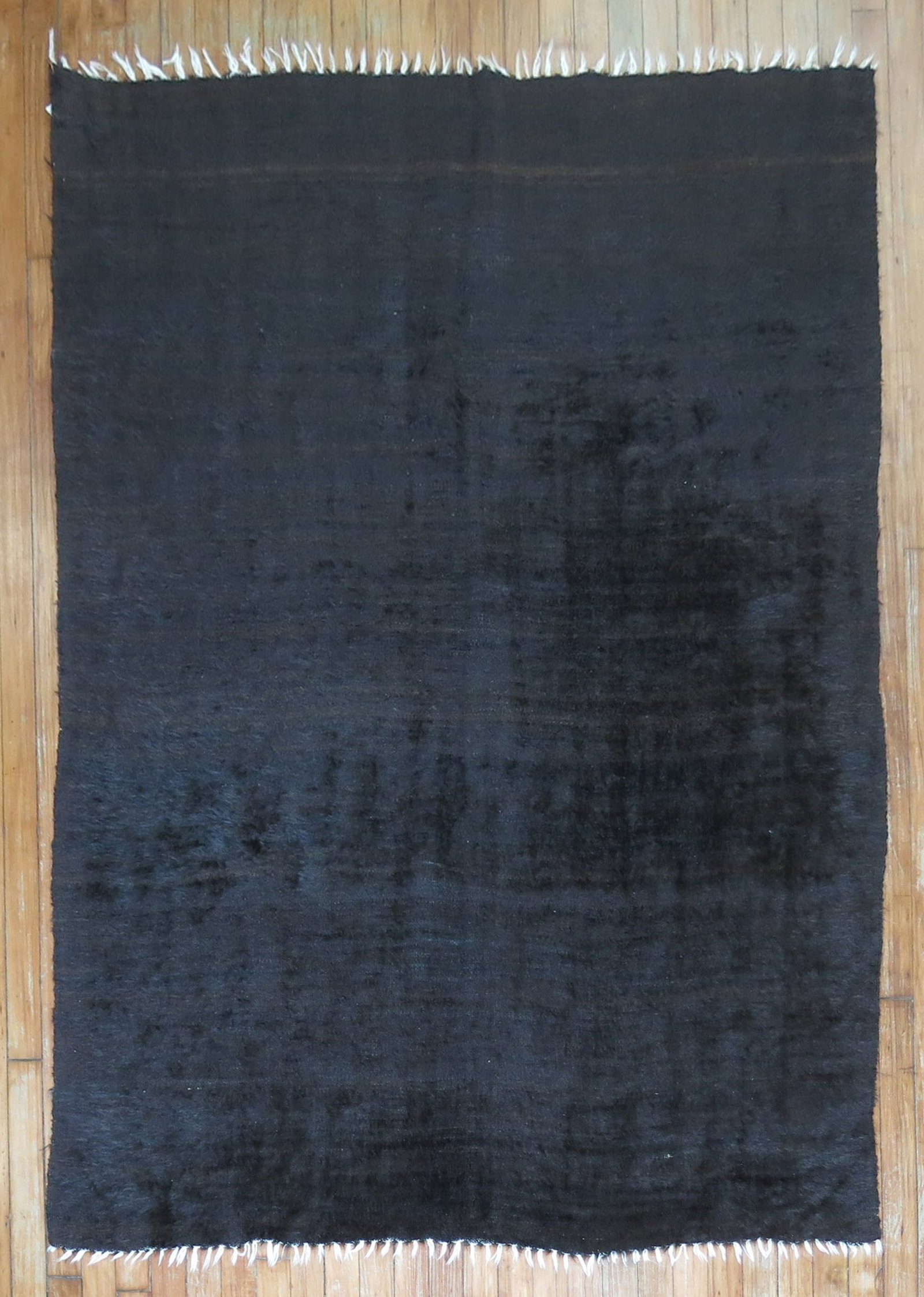 4' 6" x 6' 3" Black Angora Mohair Accent Rug: 4' 6" x 6' 3" Black Angora Mohair Accent Rug Mid-century Angora mohair accent rug in black. This pre-owned carpet offers a classic look and is described as an Angora mohair piece. Specifications Title