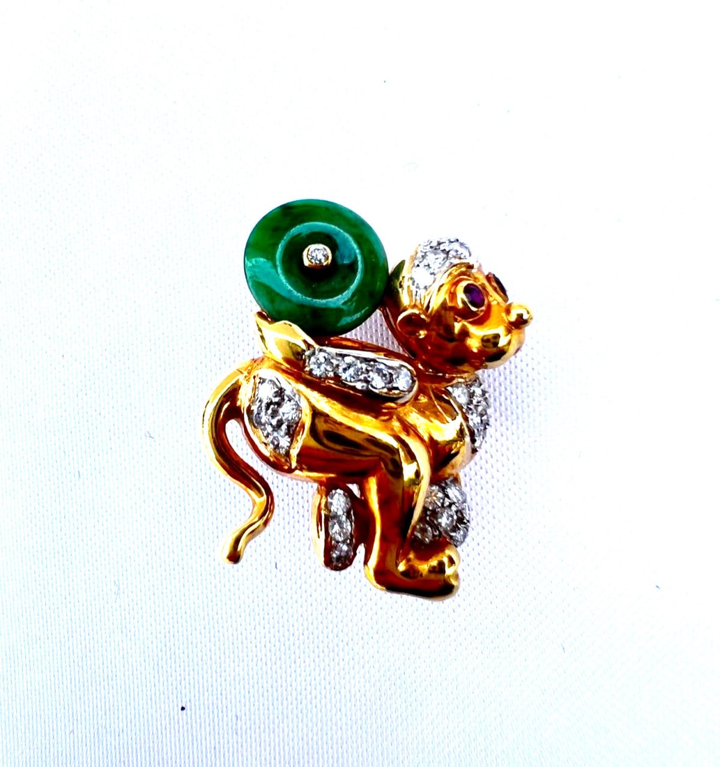 French 18K Gold Monkey Brooch with Diamonds Rubies and Jade: French 18K Gold Monkey Brooch with Diamonds Rubies and Jade This exquisite French brooch features a charming monkey design crafted from 18K yellow gold, adorned with sparkling diamonds, vibrant rubies