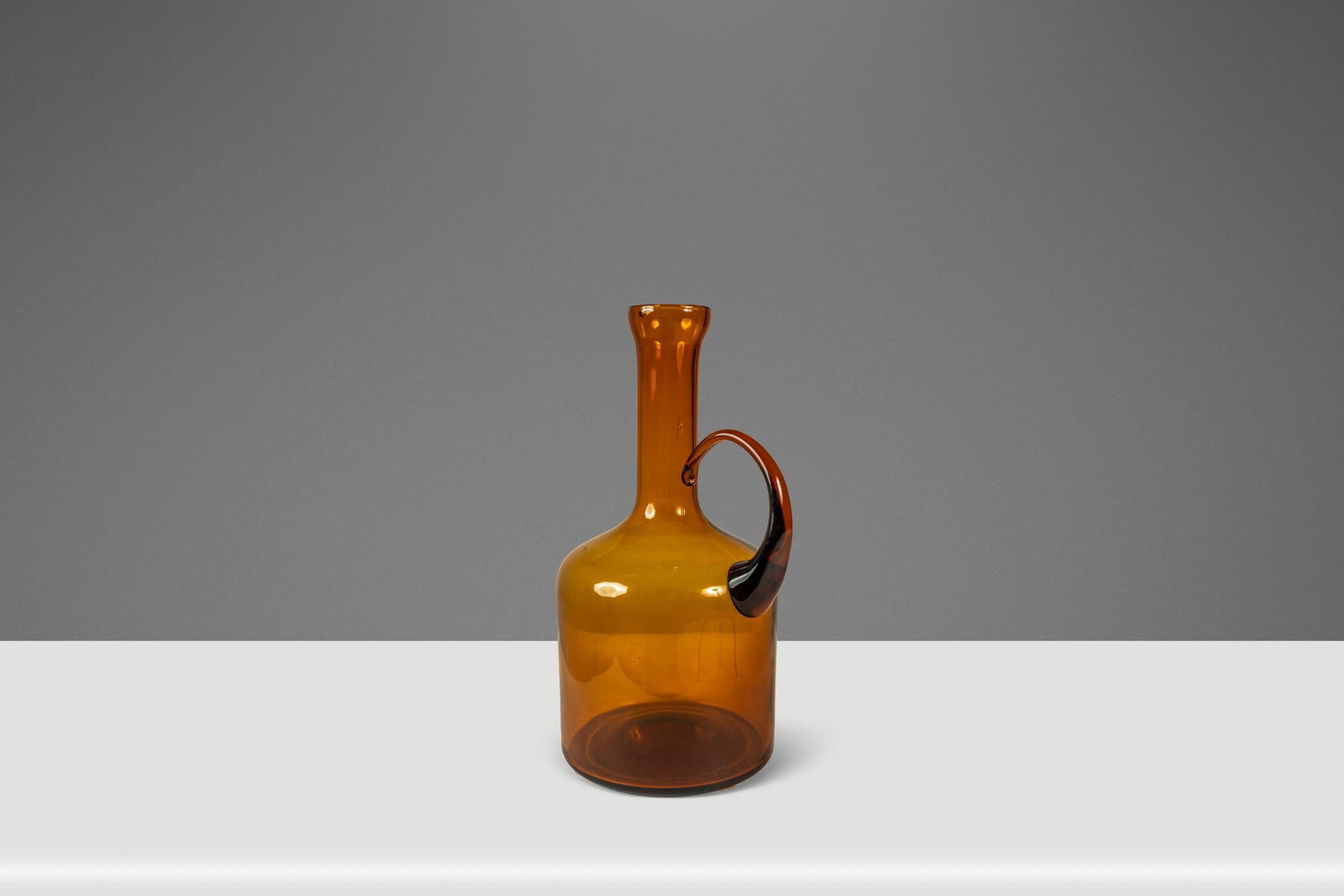 Amber Blown Glass Studio Vessel Mid-Century Modern USA Circa 1970s: Amber Blown Glass Studio Vessel Mid-Century Modern USA Circa 1970s This Mid-Century Modern abstract studio craft vessel is hand-blown from amber glass and dates to the 1970s in the United States. Vers