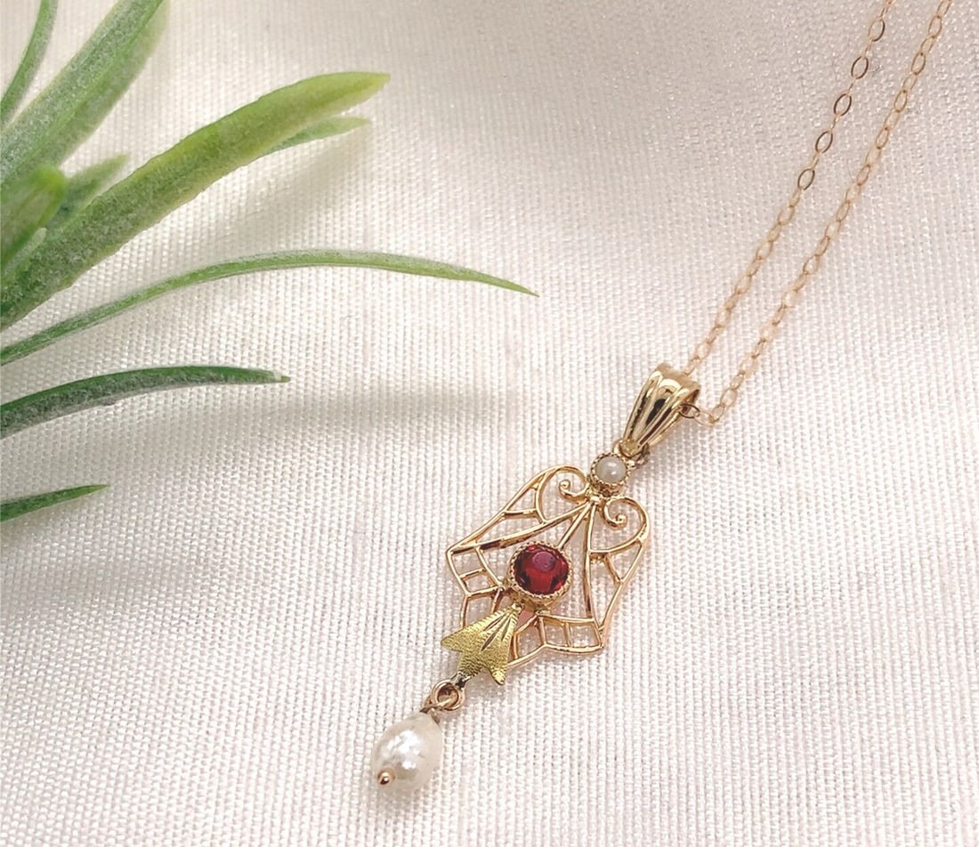 10k Yellow Gold Lavaliere Necklace with Pearl Drop and Red Glass Accent: 10k Yellow Gold Lavaliere Necklace with Pearl Drop and Red Glass Accent This exquisite 10k Yellow Gold Lavaliere showcases a stunning freshwater pearl drop paired with a vibrant red glass accent. The 