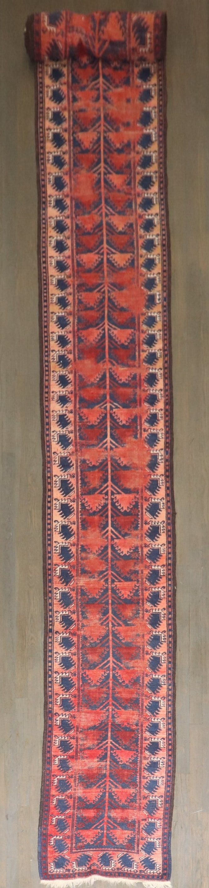 2' x 19' 9" Balouch Runner Antique Long Narrow Rug: 2' x 19' 9" Balouch Runner Antique Long Narrow Rug Early 20th-century Balouch runner with a long, narrow profile and worn character. This pre-owned rug is identified as a Balouch runner and noted in a