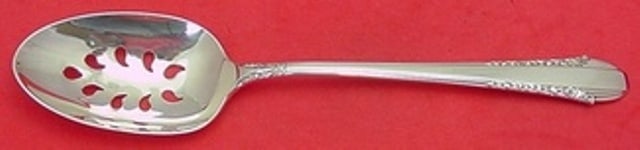 International Enchantress Sterling Silver Slotted Serving Spoon 8 1/2 Custom: International Enchantress Sterling Silver Slotted Serving Spoon 8 1/2 Custom Sterling silver serving spoon by International in the Enchantress pattern. This post-1940 piece is a pierced, 9-hole custom