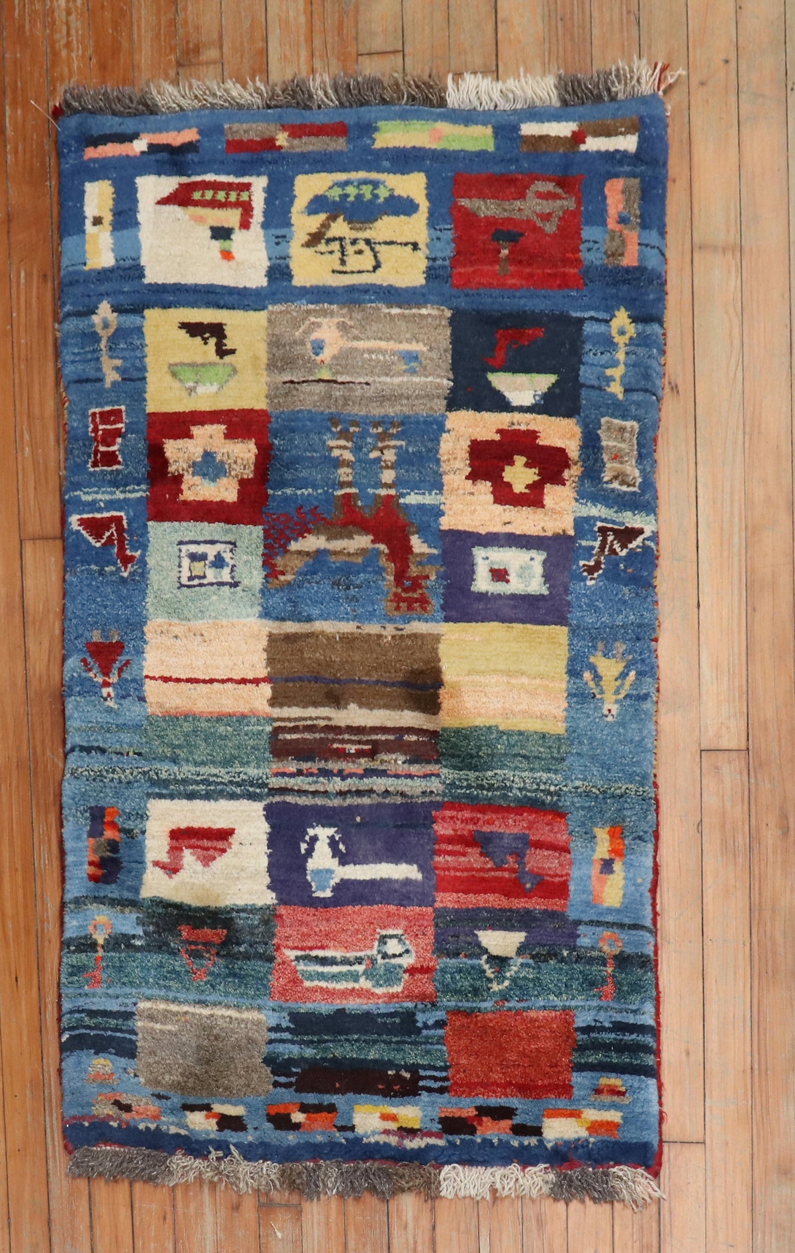 2' 7" x 4' 4" Persian Gabbeh pictorial area rug: 2' 7" x 4' 4" Persian Gabbeh pictorial area rug 21st century Persian Gabbeh rug featuring a pictorial motif. This pre-owned small rug offers a modern folk design in a compact format. Specifications It