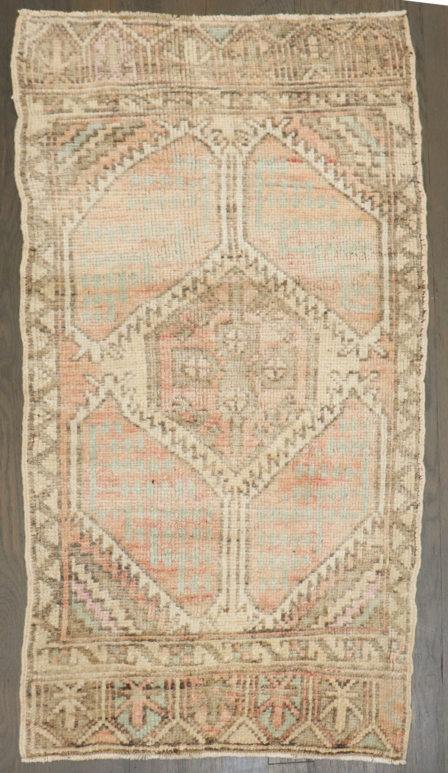 1' 8" x 3' 3" Anatolian Yastik Rug Turkish Mid 20th Century: 1' 8" x 3' 3" Anatolian Yastik Rug Turkish Mid 20th Century Vintage Turkish mini rug in a peach colorway. This mid-20th century Anatolian yastik is a pre-owned piece with a compact size suitable for s