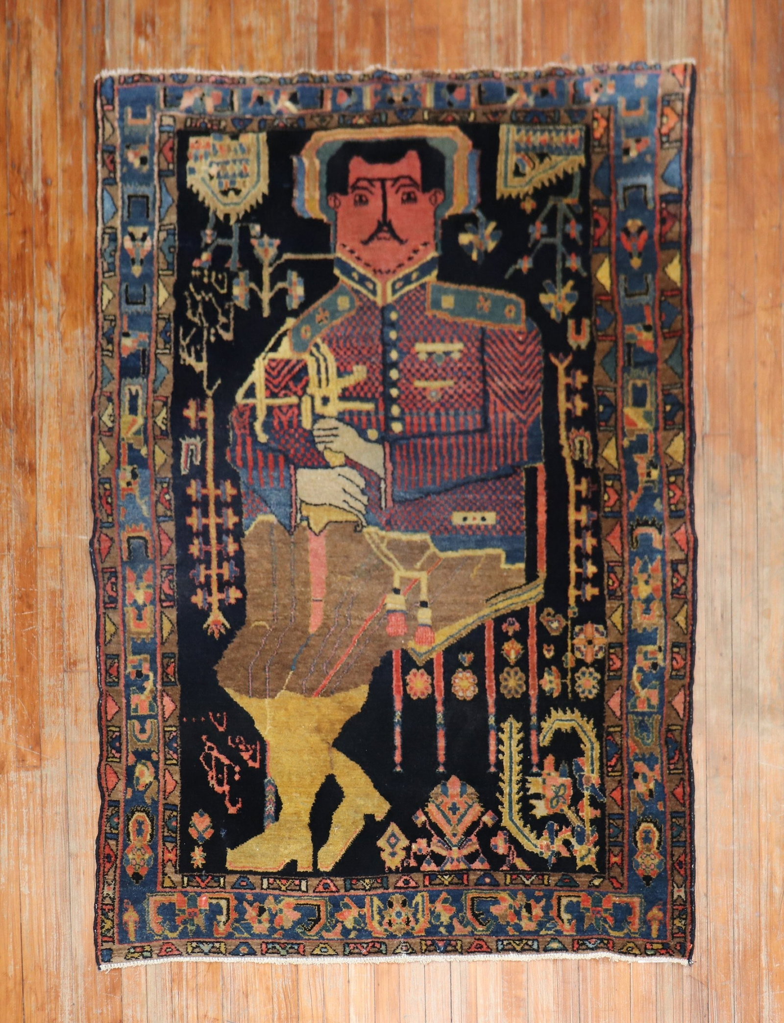4' 6" x 6' 6" Hamadan pictorial rug Colonel Mohammad Tagi-Khan: 4' 6" x 6' 6" Hamadan pictorial rug Colonel Mohammad Tagi-Khan Mid-20th century Persian Kurd pictorial rug featuring a depiction of Colonel Mohammad Tagi-Khan. This pre-owned accent rug is identified 